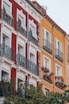 a red and white building with balconies and windows