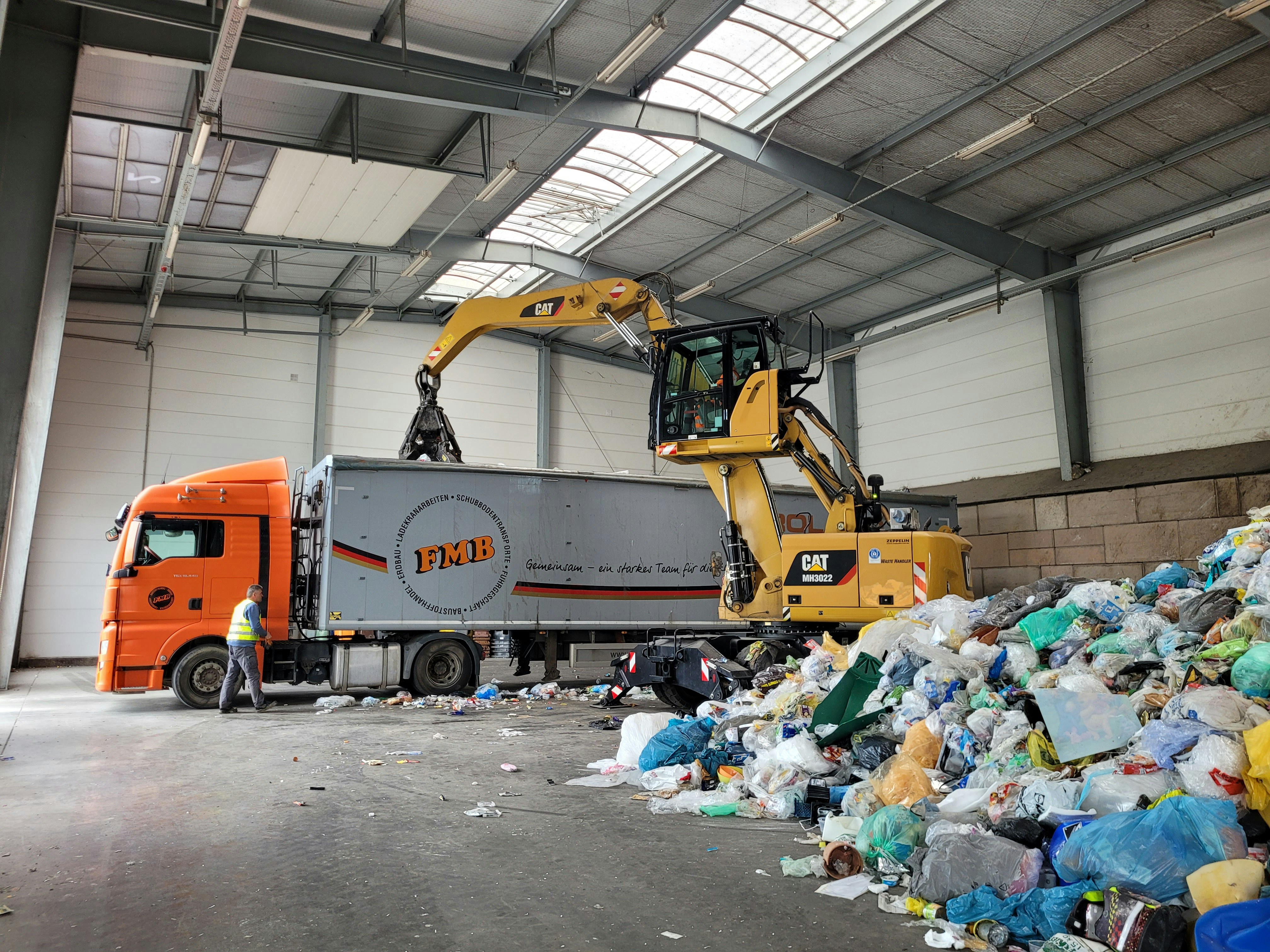 Backhoe loader in a German landfill, Germany