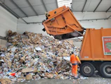 a man standing next to a pile of trash