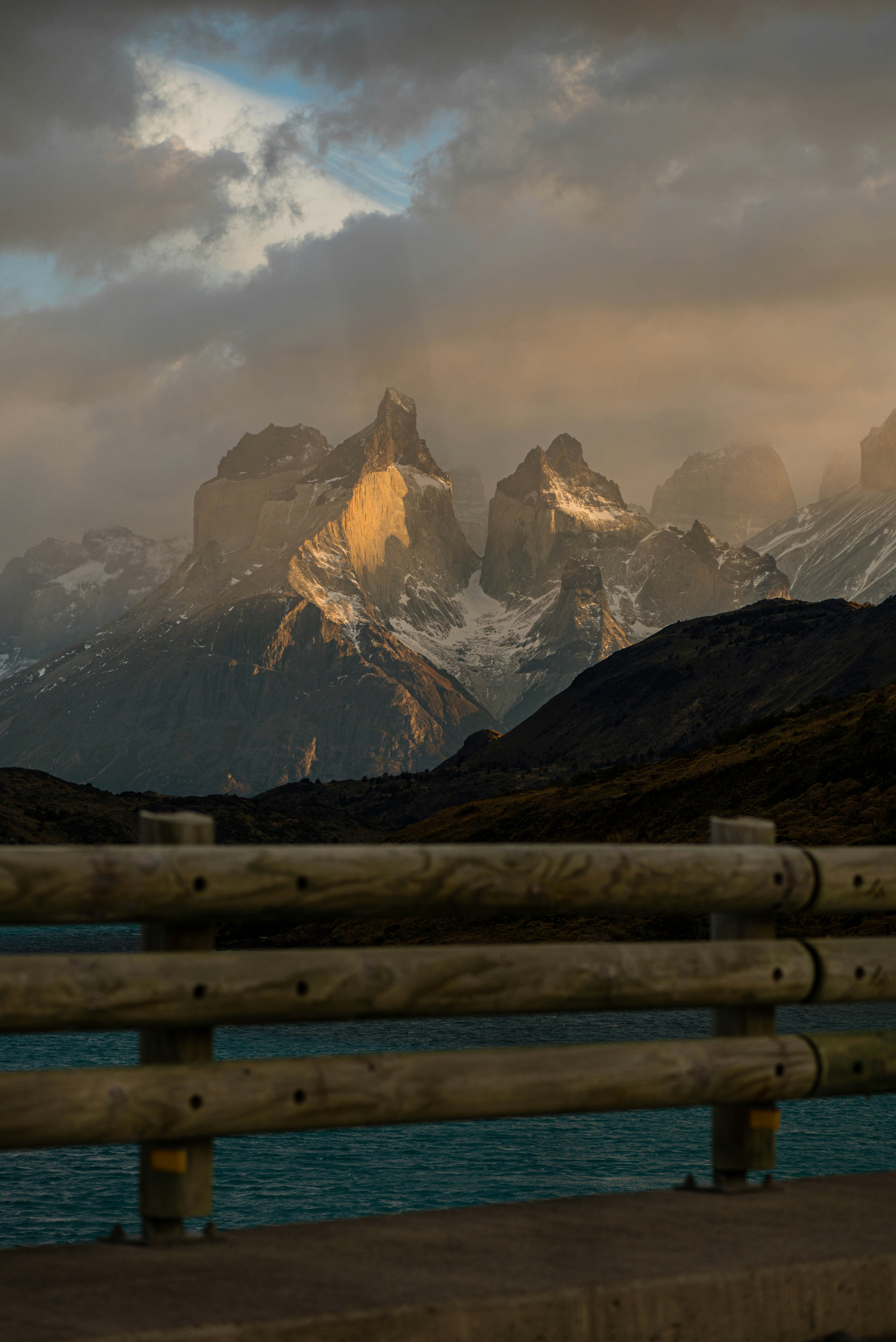 a wooden bench sitting next to a body of water
