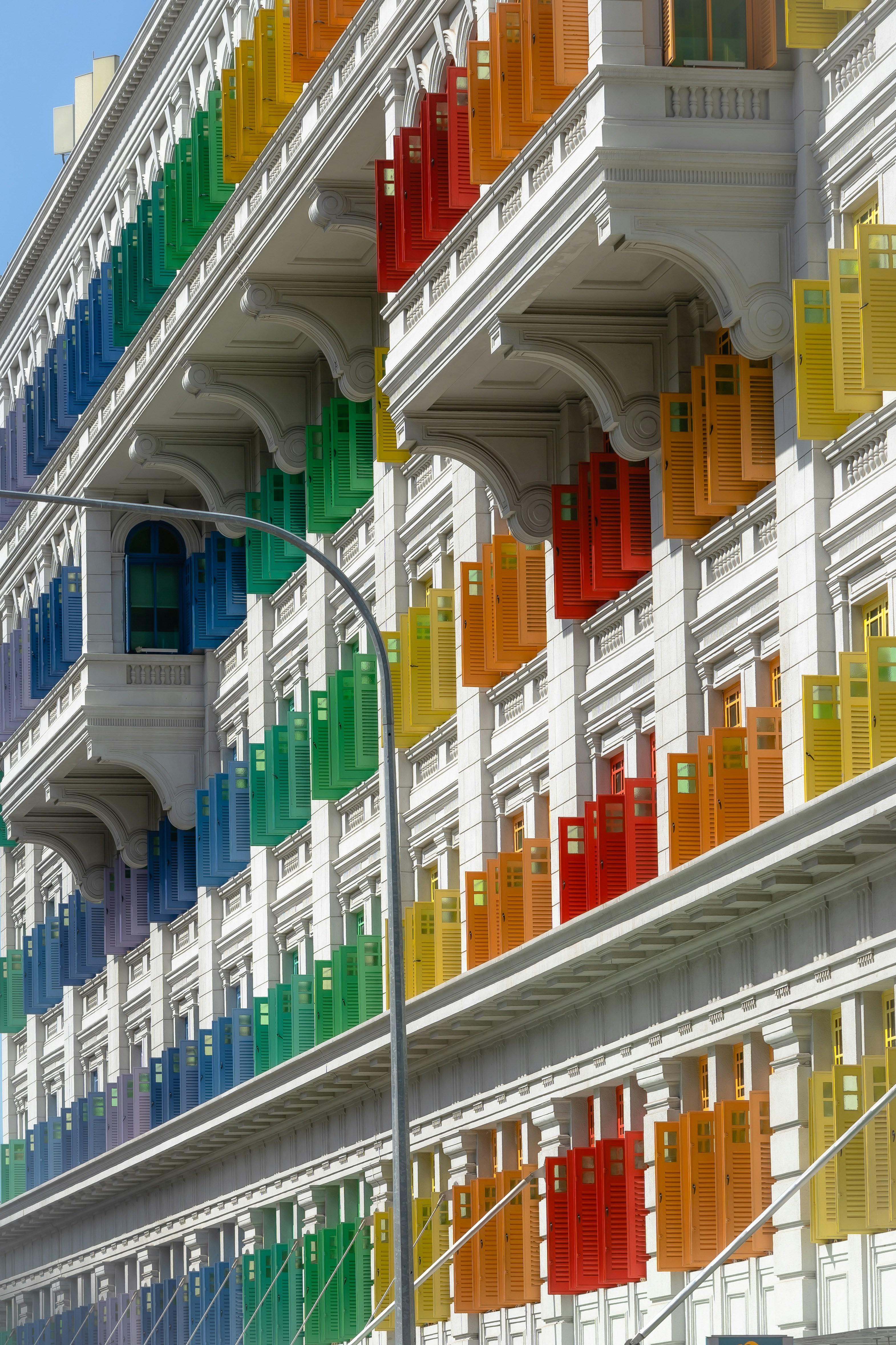 A multicolored building with a street light in front of it photo – Free ...