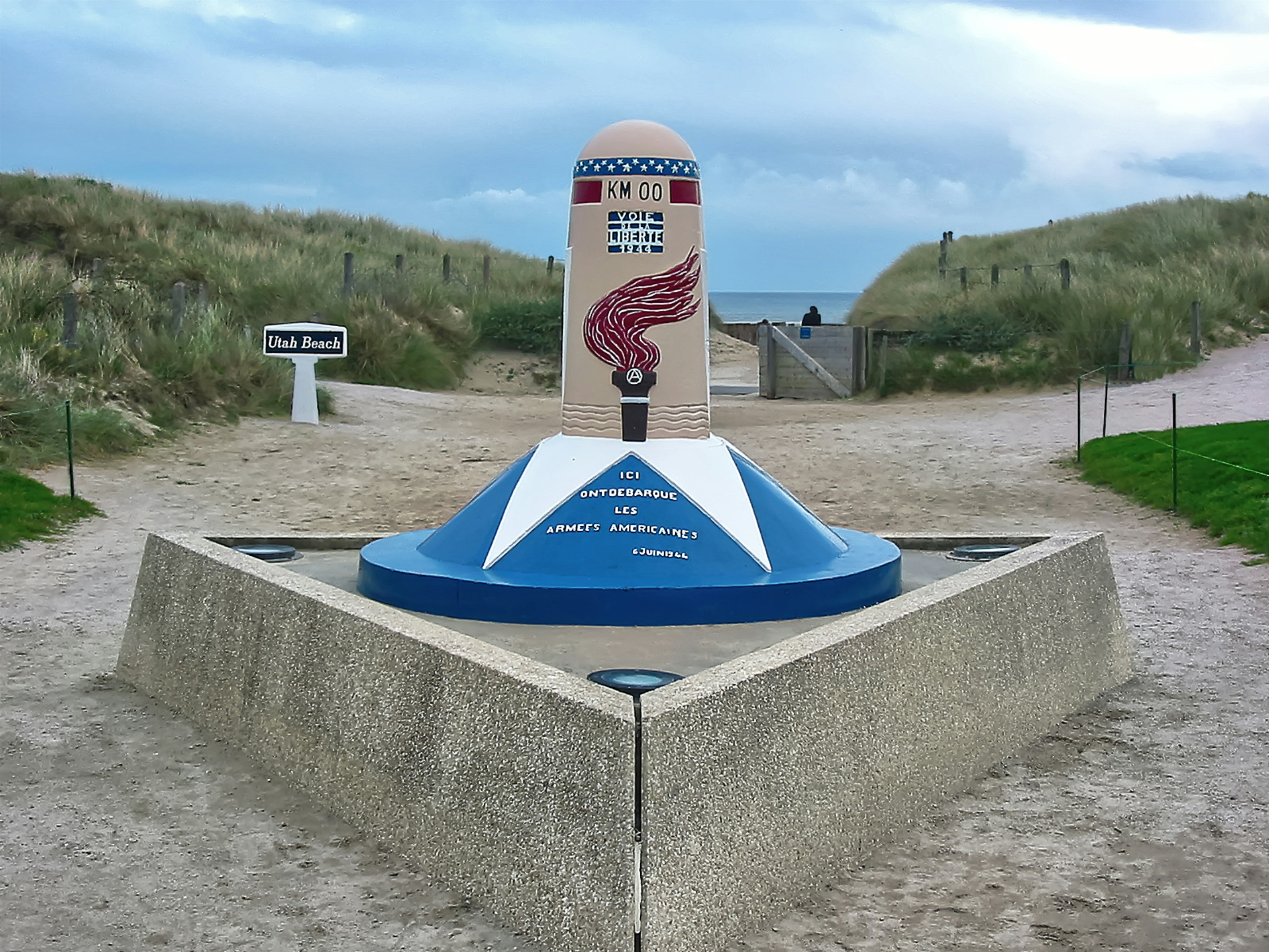 a large blue and white object sitting on top of a cement wall