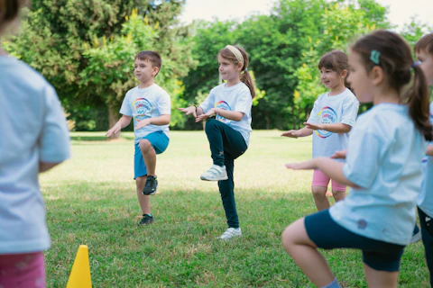 a group of young children playing a game of frisbee