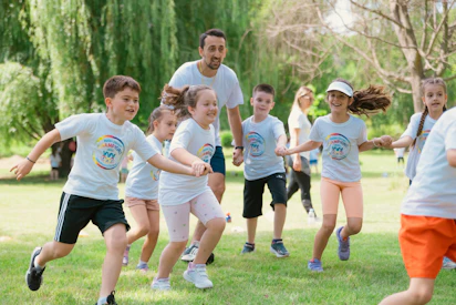 a group of young children playing a game of frisbee