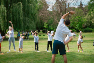 a group of people doing yoga in a park