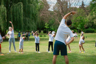 a group of people doing yoga in a park
