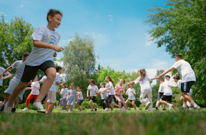 a group of young people playing a game of frisbee