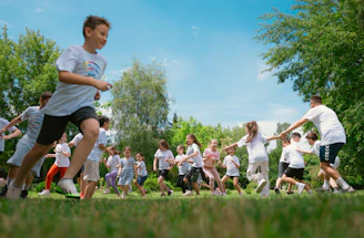 a group of young people playing a game of frisbee