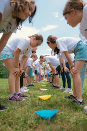 a group of young girls playing a game of frisbee