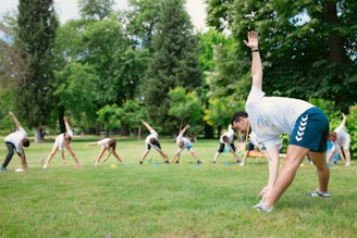 a group of people doing yoga in a park