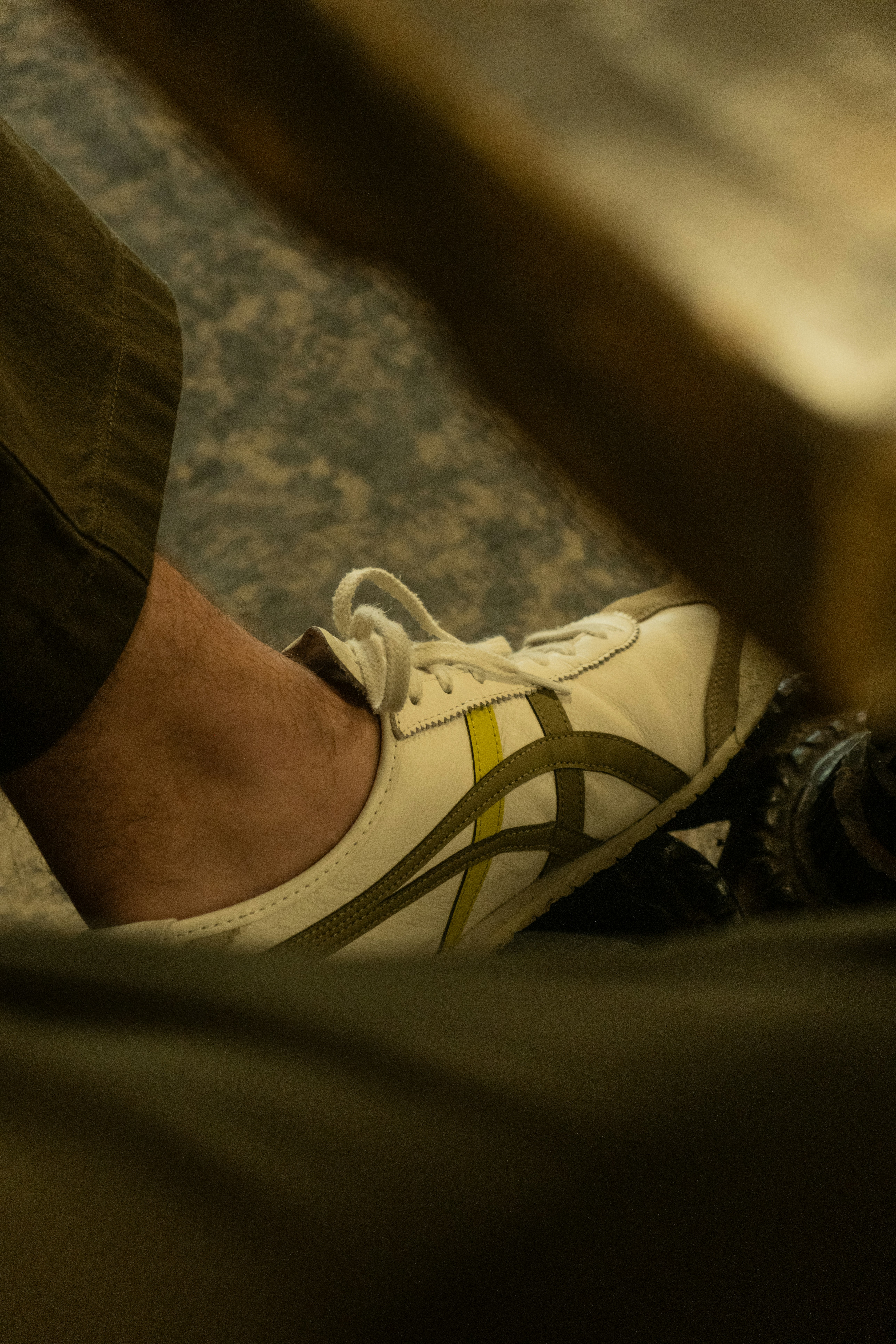 A person standing next to a wooden bench