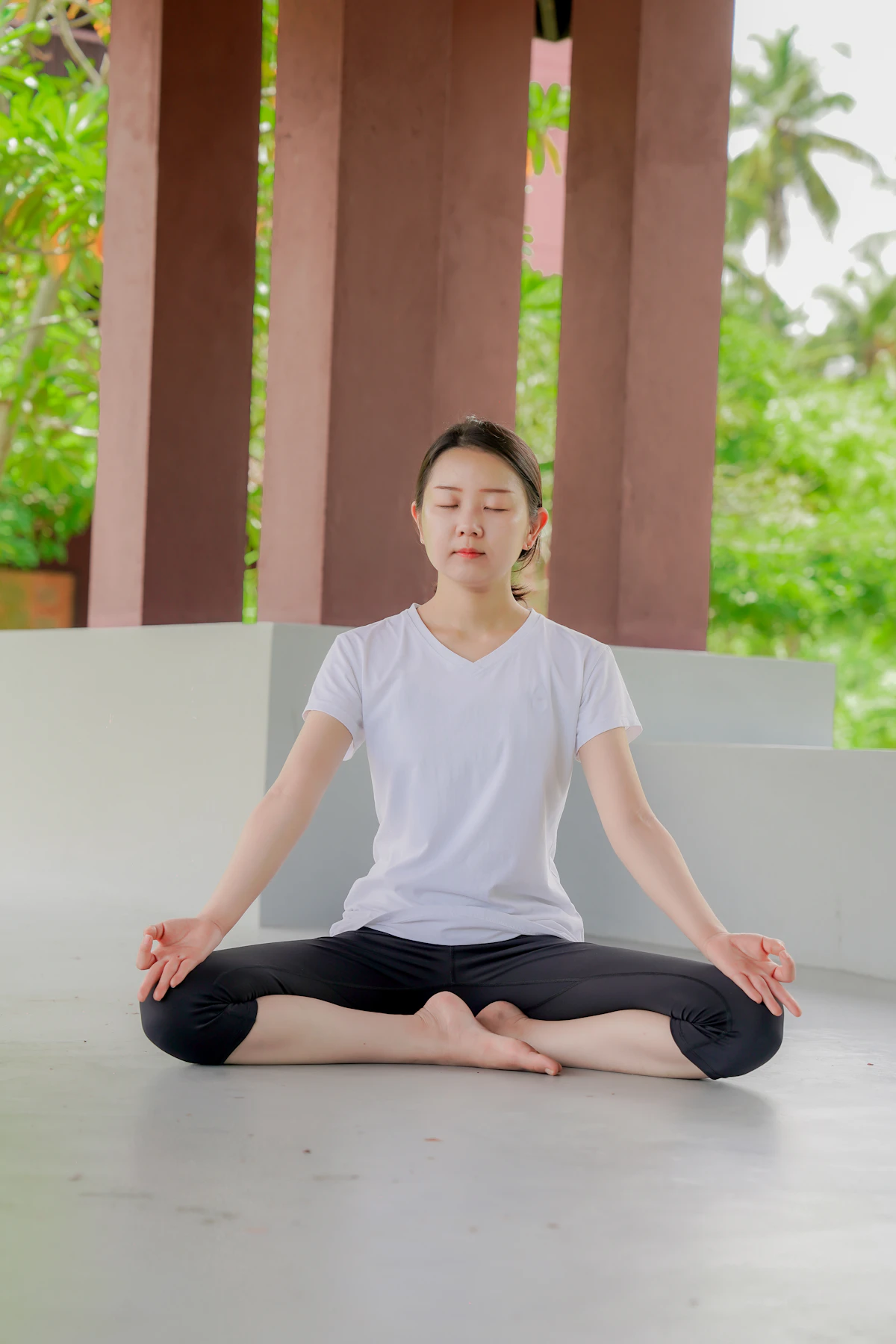 Person seated in a cross-legged meditation pose, illustrating the contemplative foundation of yoga philosophy