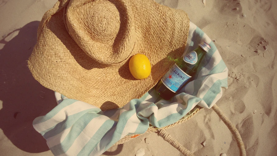 Straw hat and beach basket on the sand