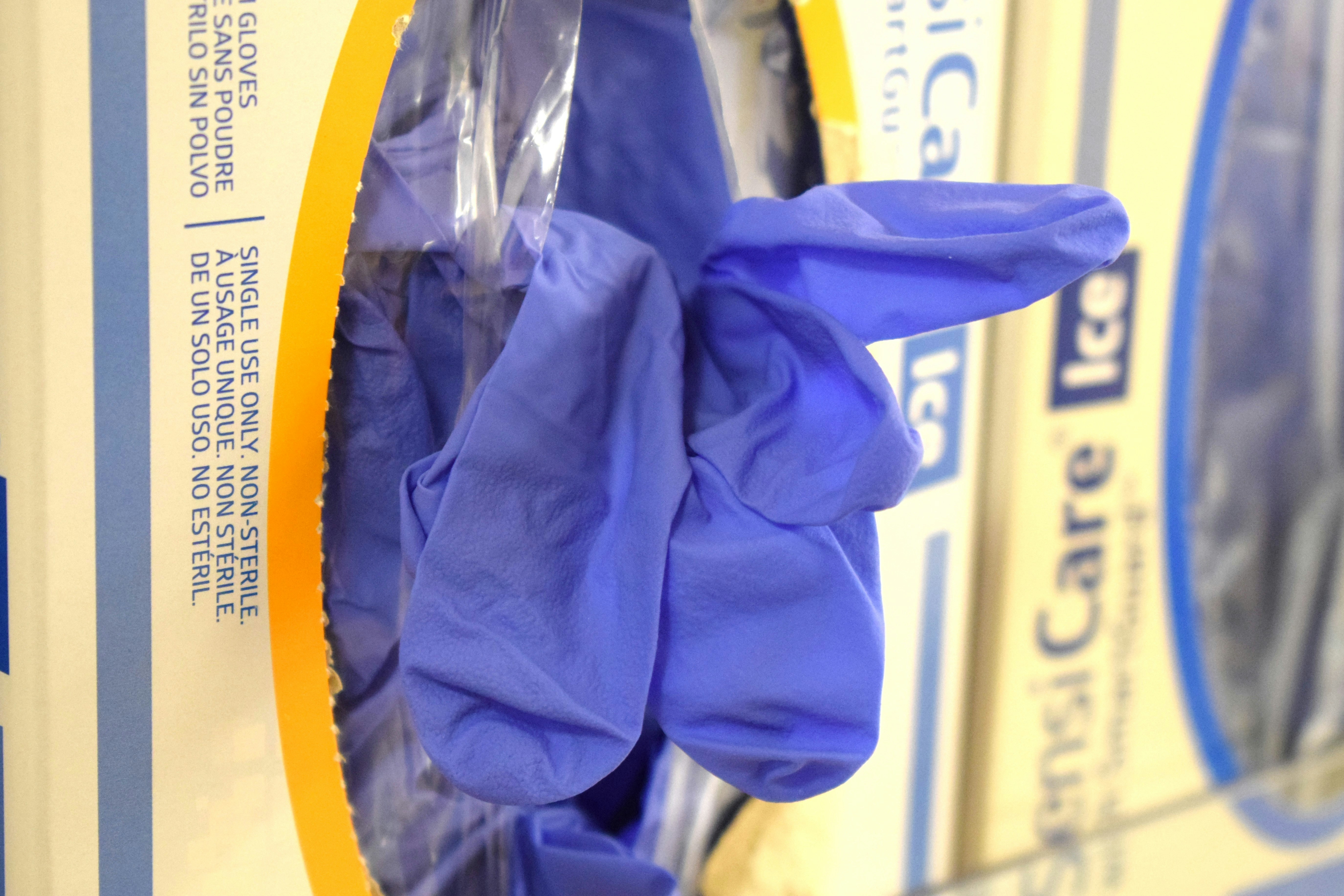 Blue nitrile disposable gloves box on clean white surface, bright lighting