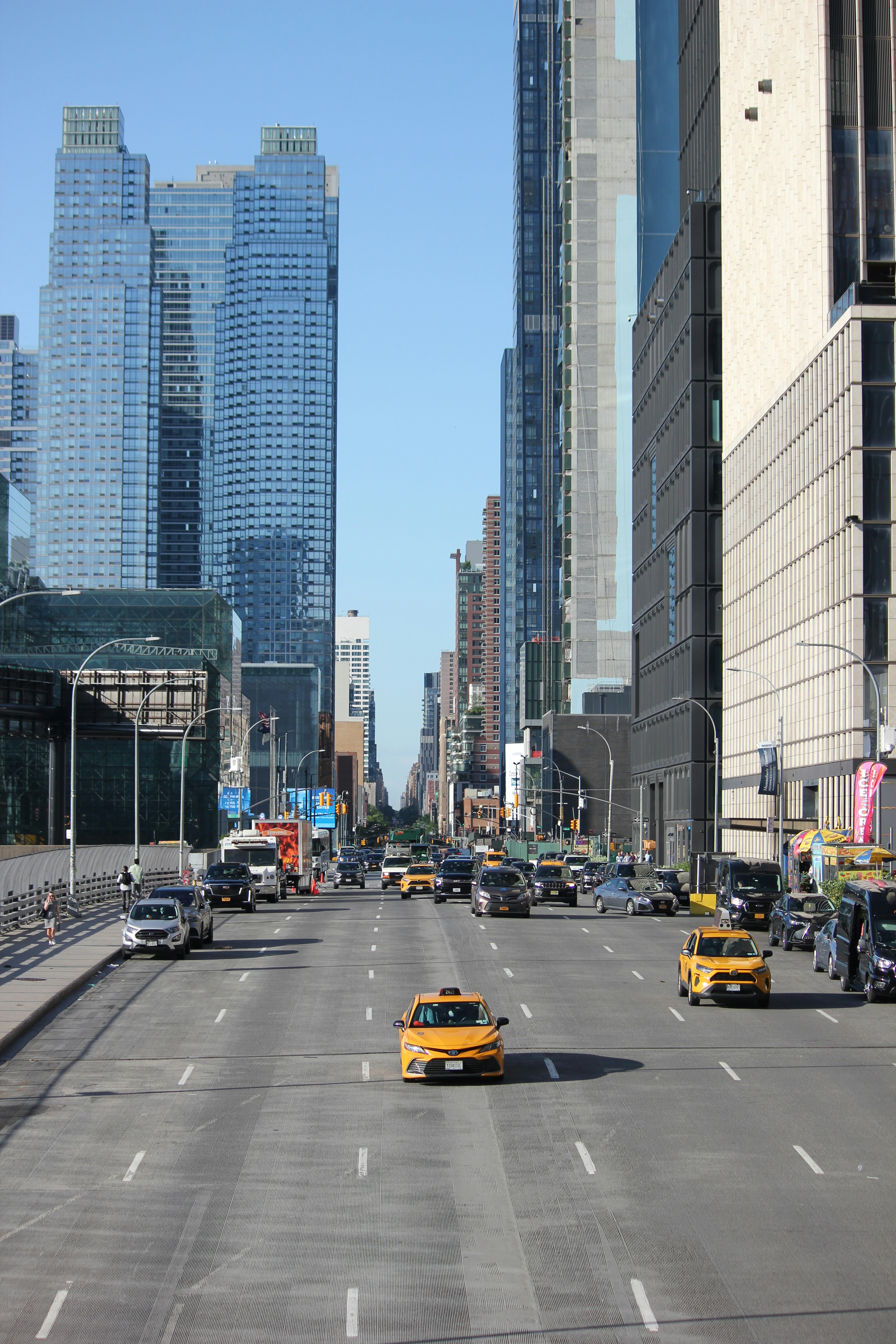 a city street filled with lots of traffic next to tall buildings