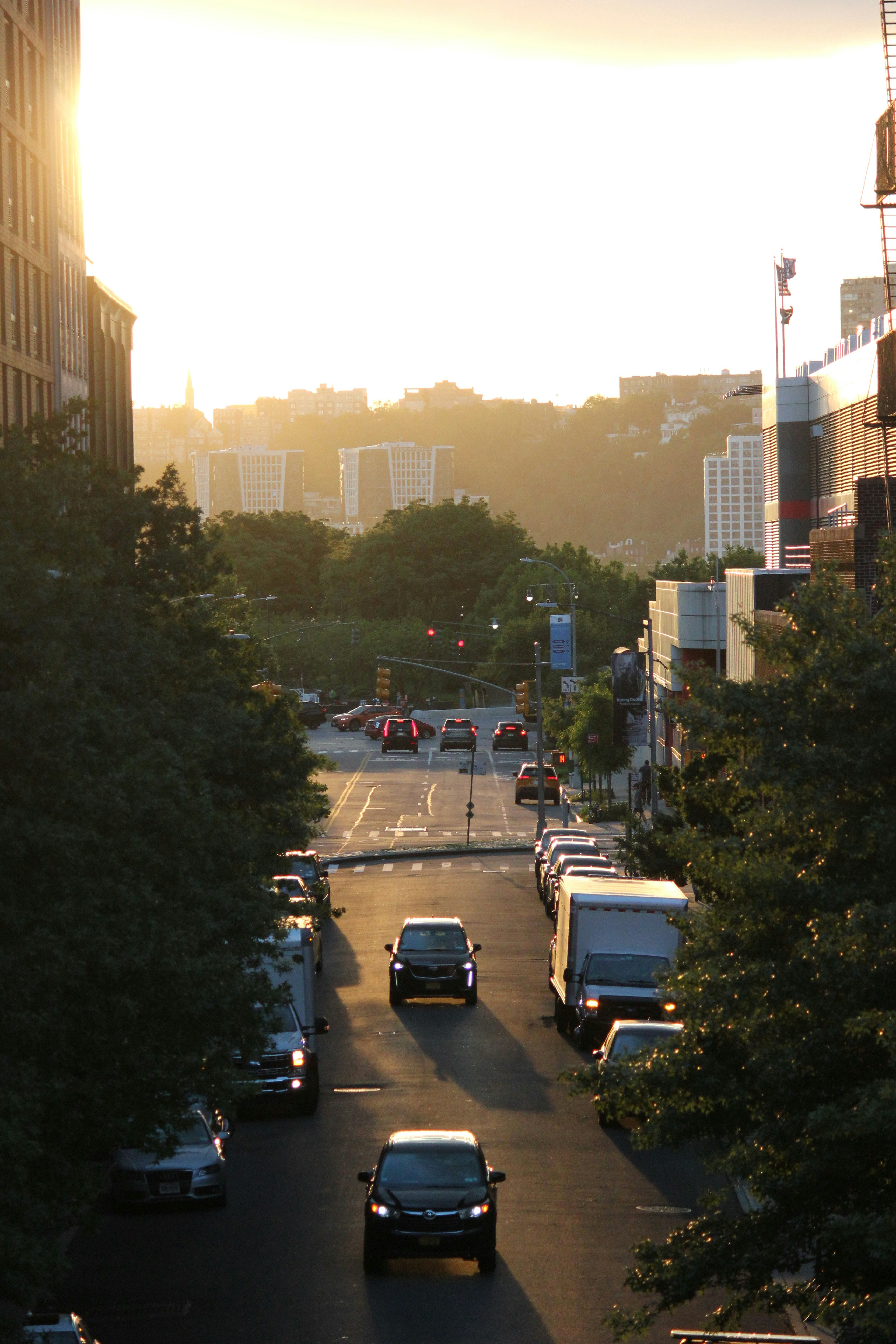 a city street filled with lots of traffic next to tall buildings