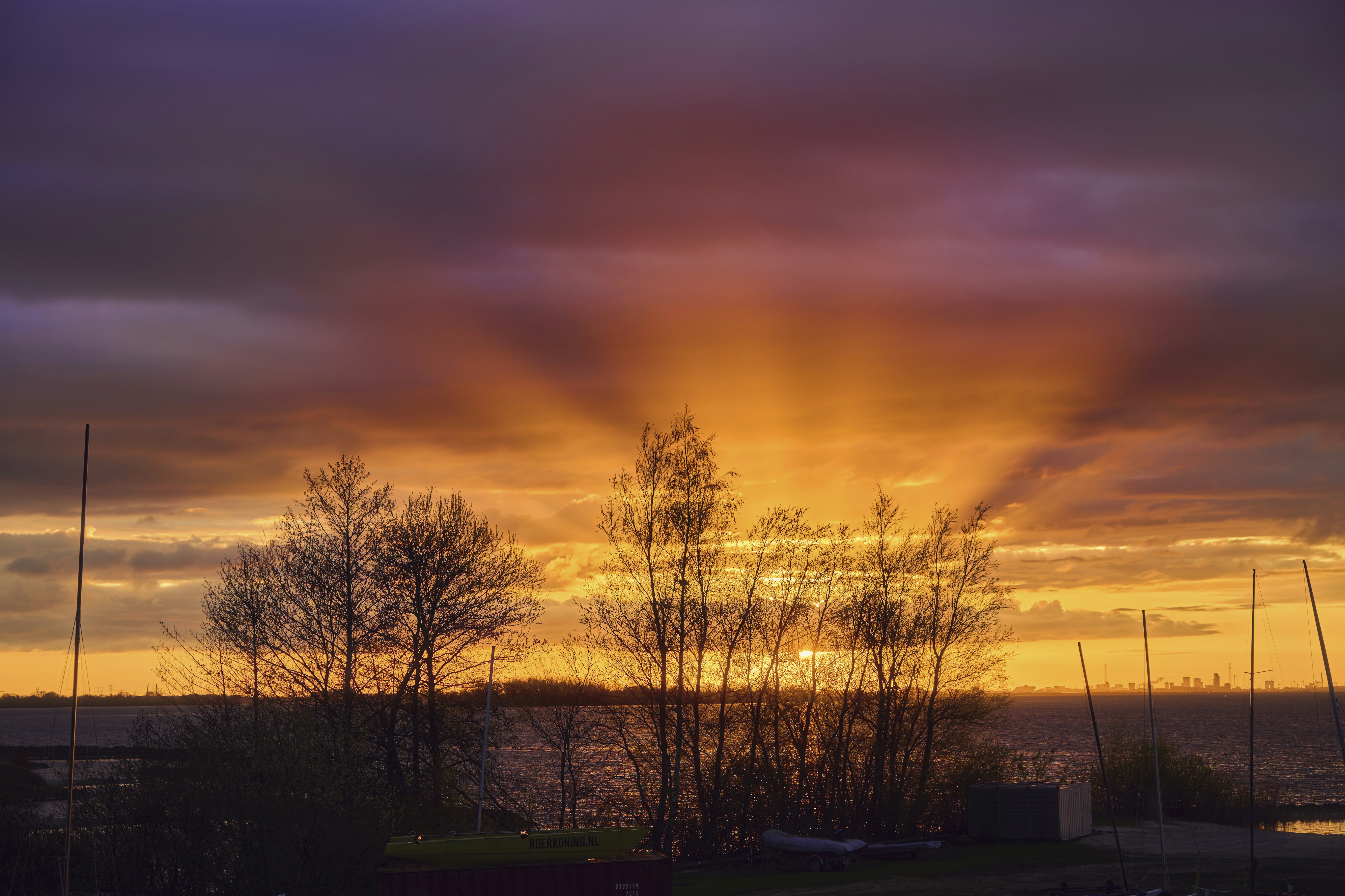 the sun is setting over a body of water