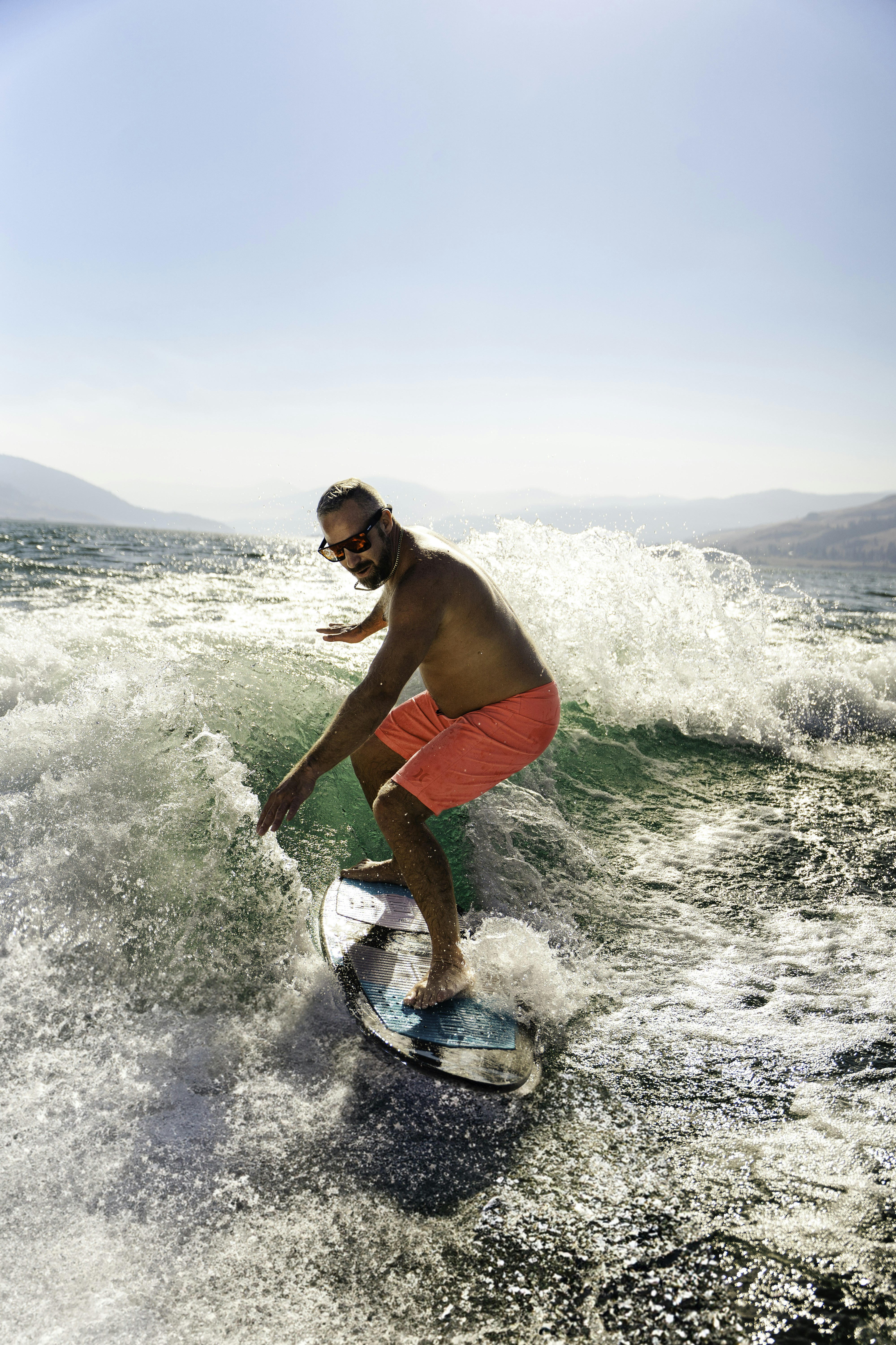 a man riding a wave on top of a surfboard