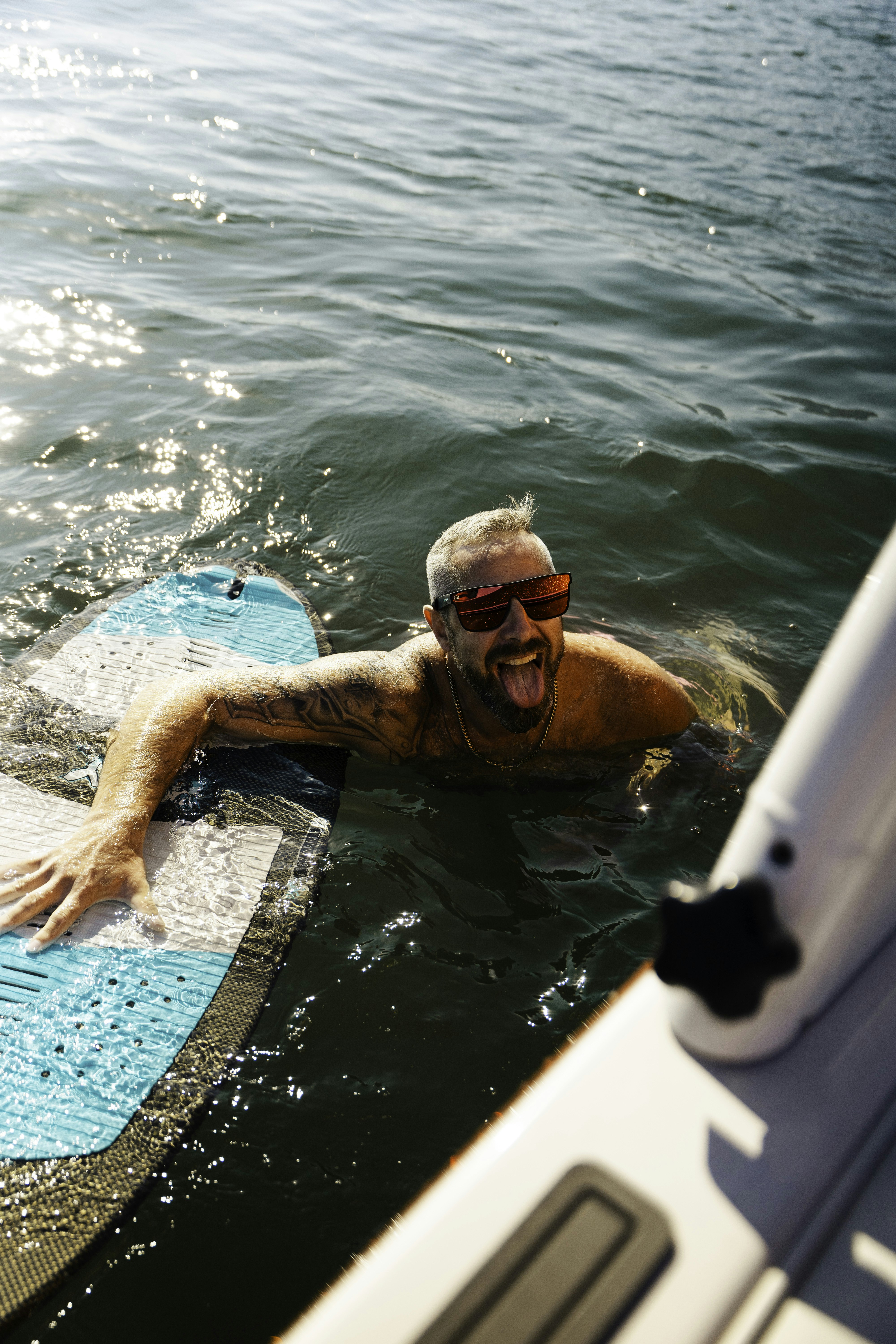 a man laying on a surfboard in the water