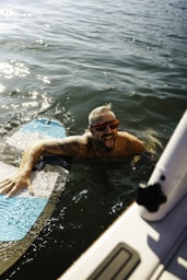 a man laying on a surfboard in the water