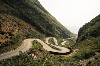 a winding road in the middle of a mountain