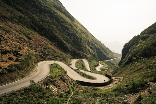a winding road in the middle of a mountain