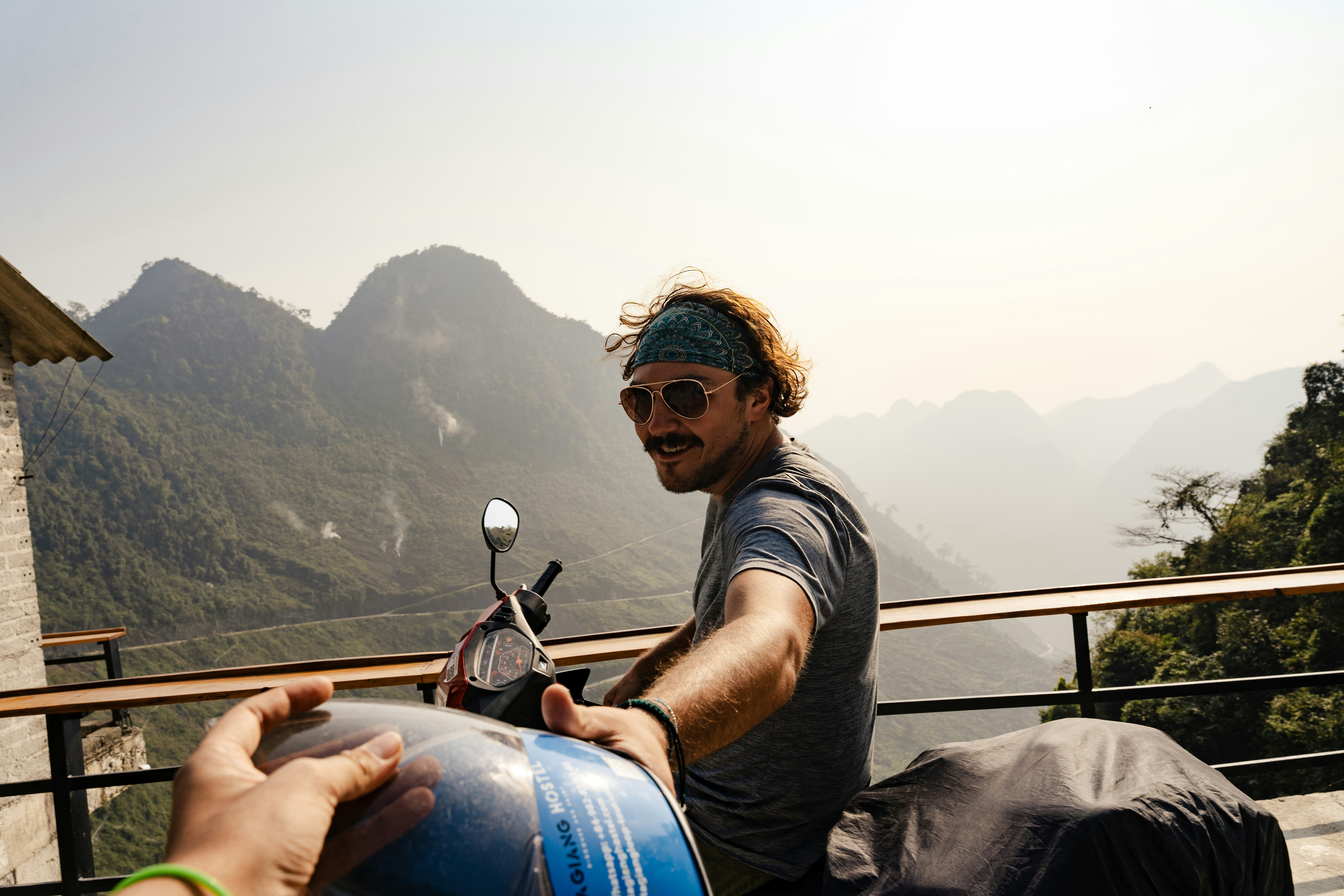 a man sitting on a motorcycle next to a woman