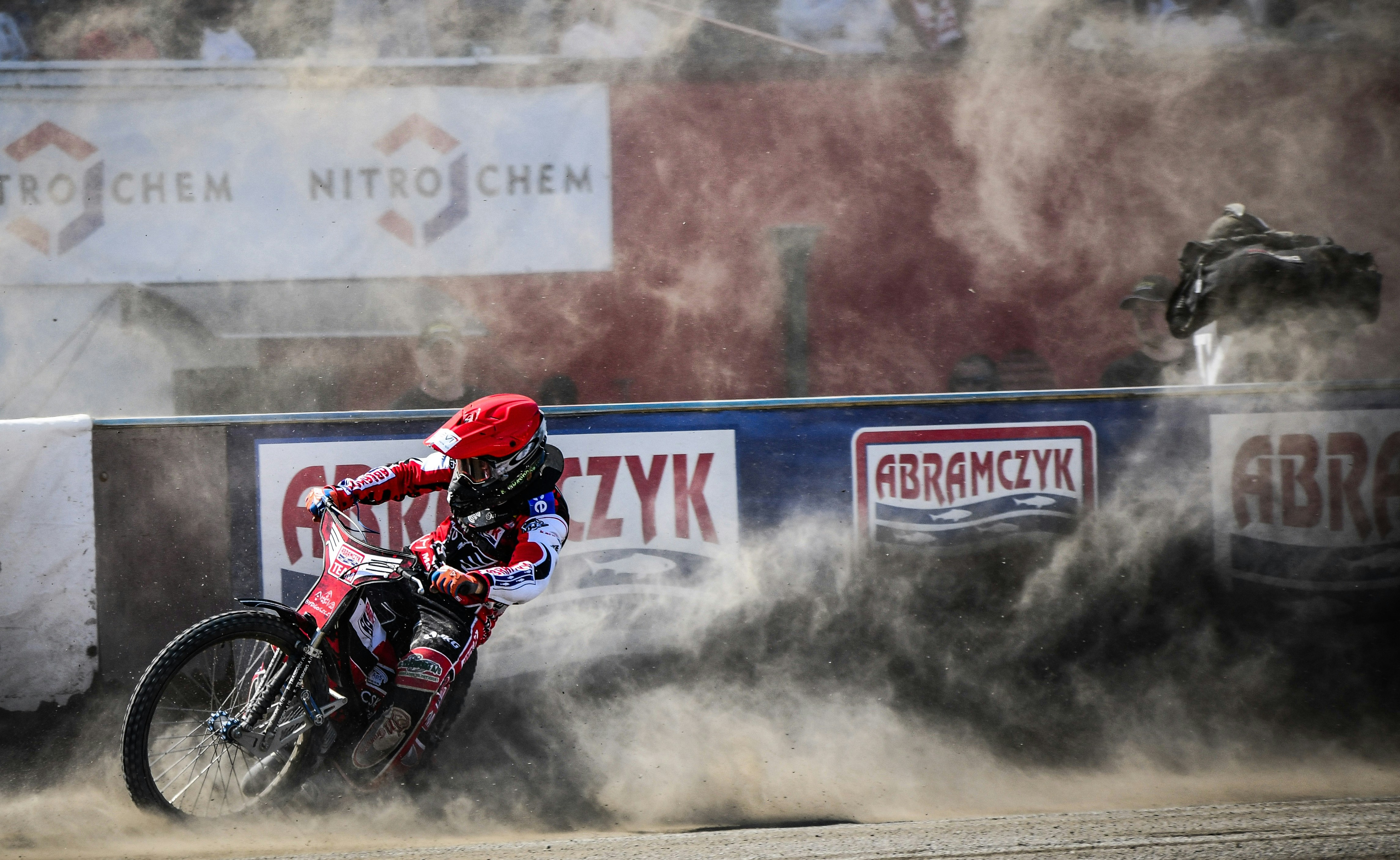 a man riding a dirt bike on top of a dirt field