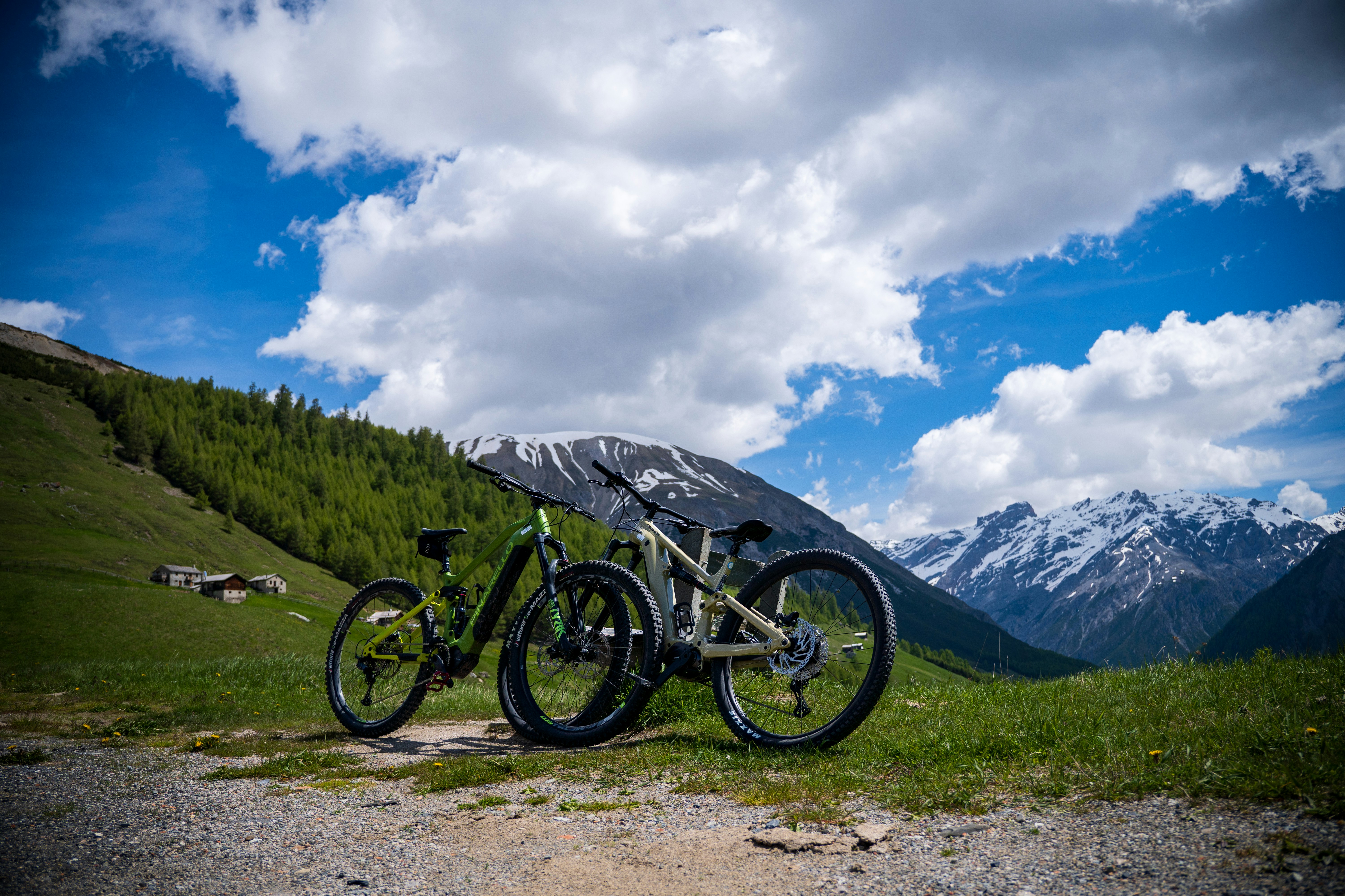 two bikes are parked on the side of a mountain