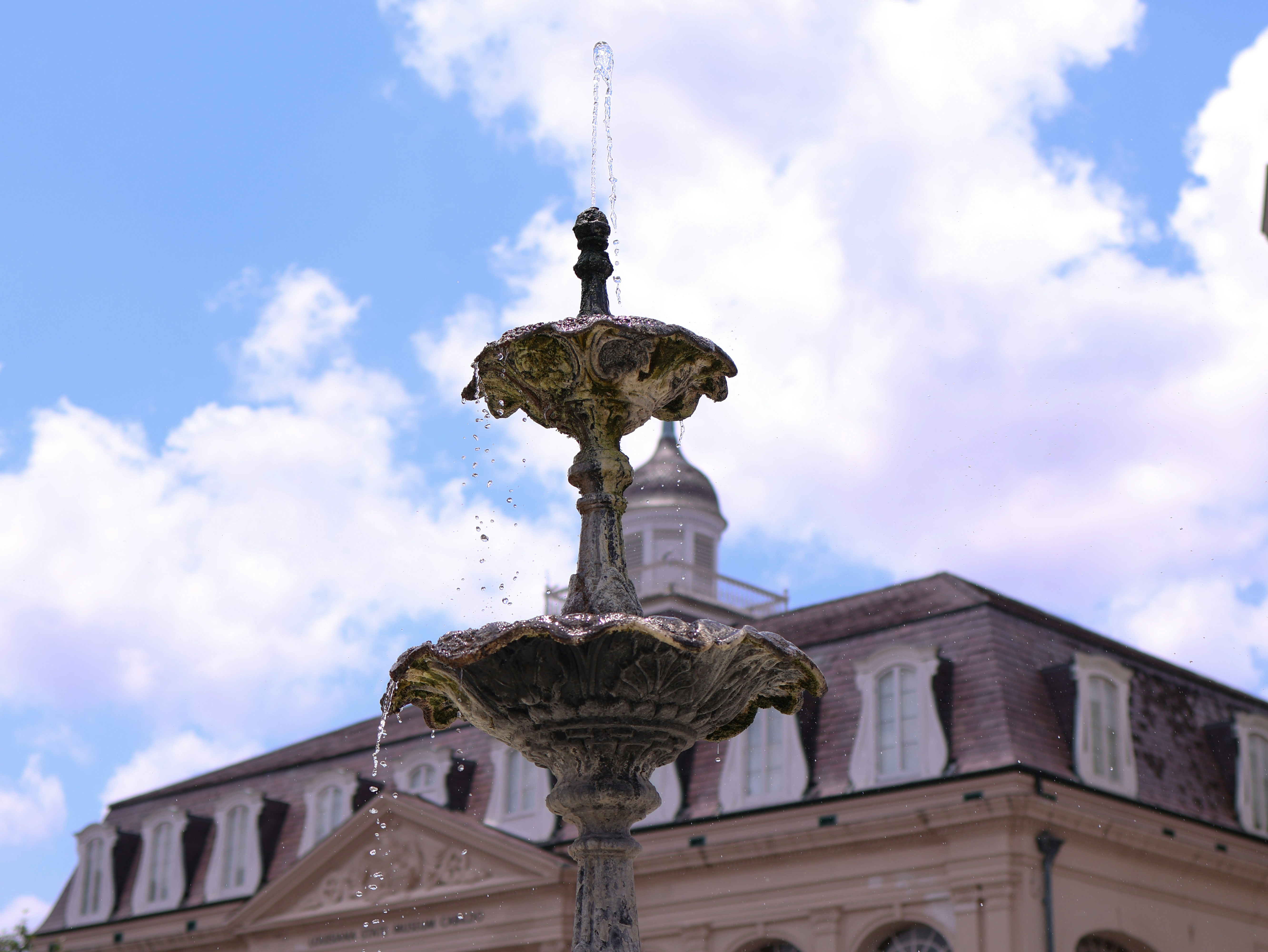 a water fountain in front of a large building