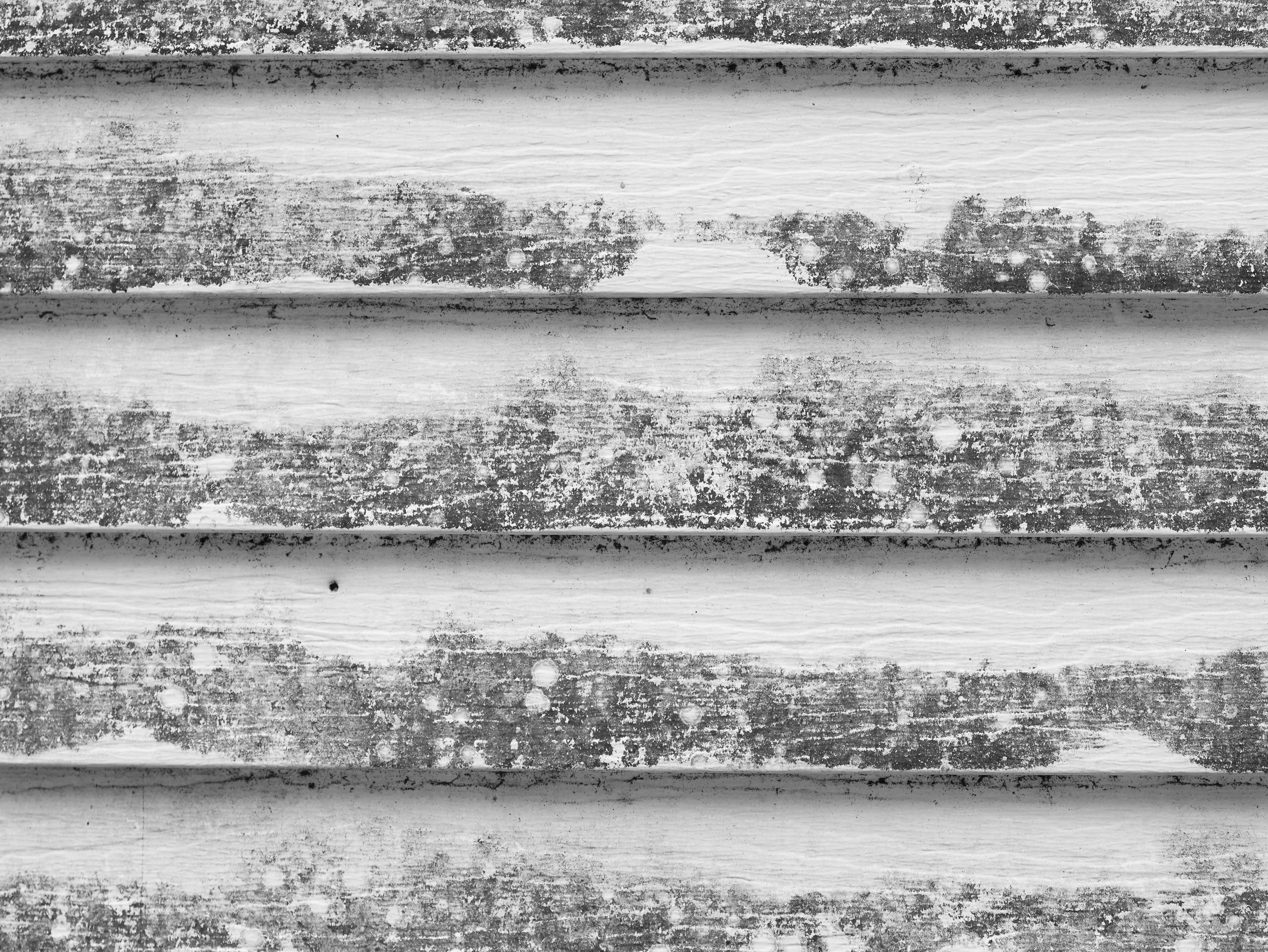 a close up of a wooden wall with peeling paint