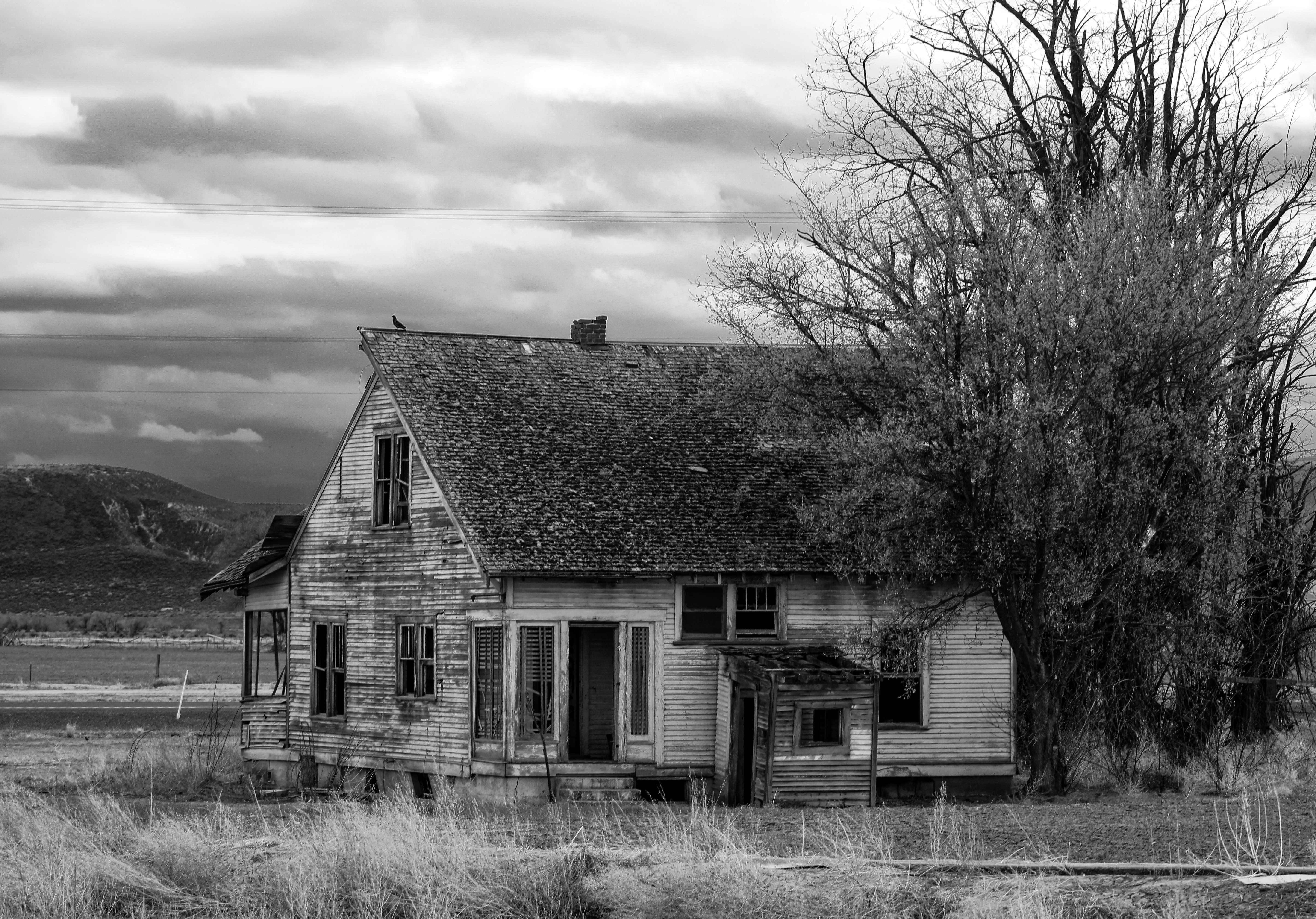 a black and white photo of an old house