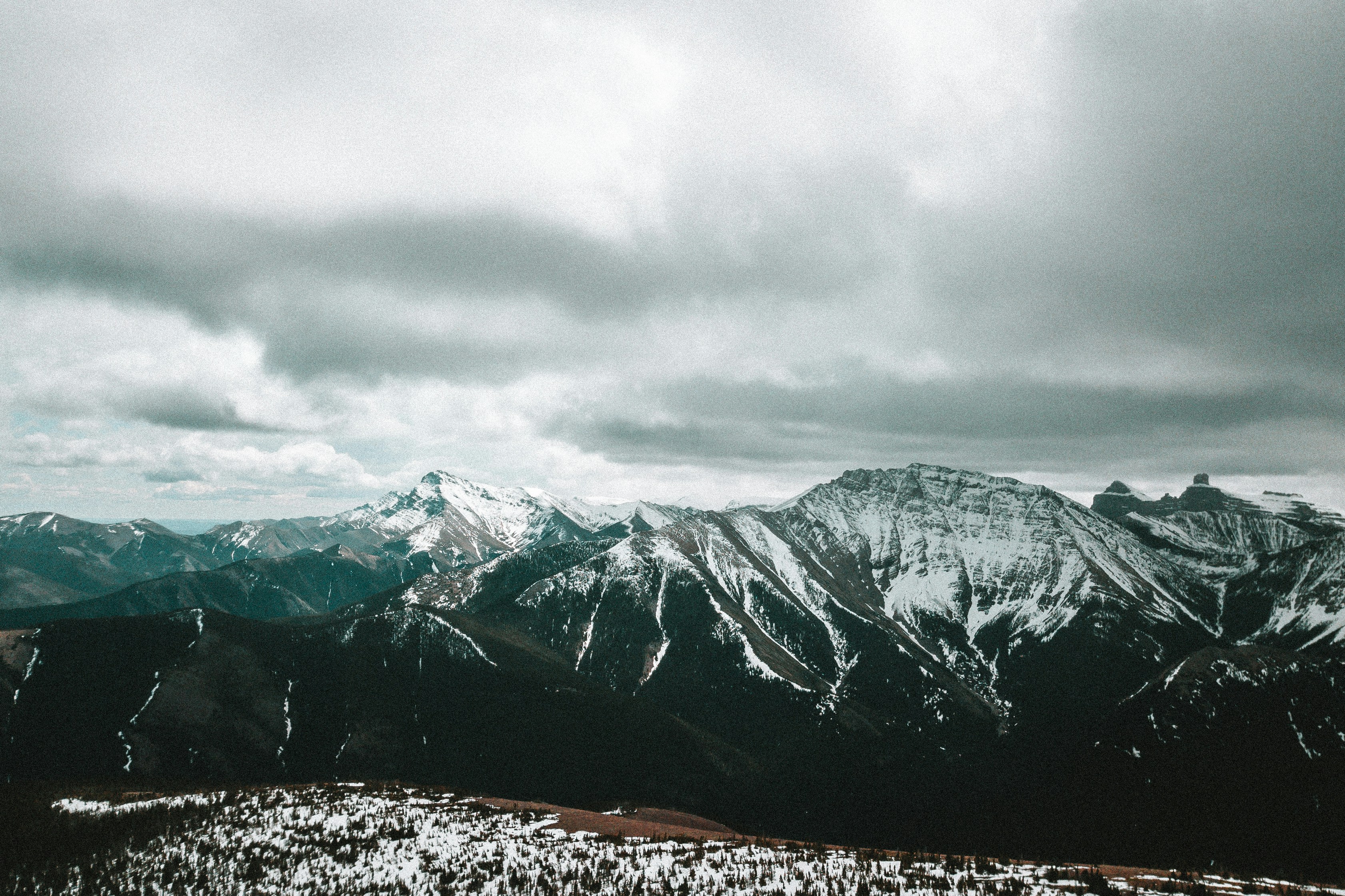 a view of a mountain range with snow on it