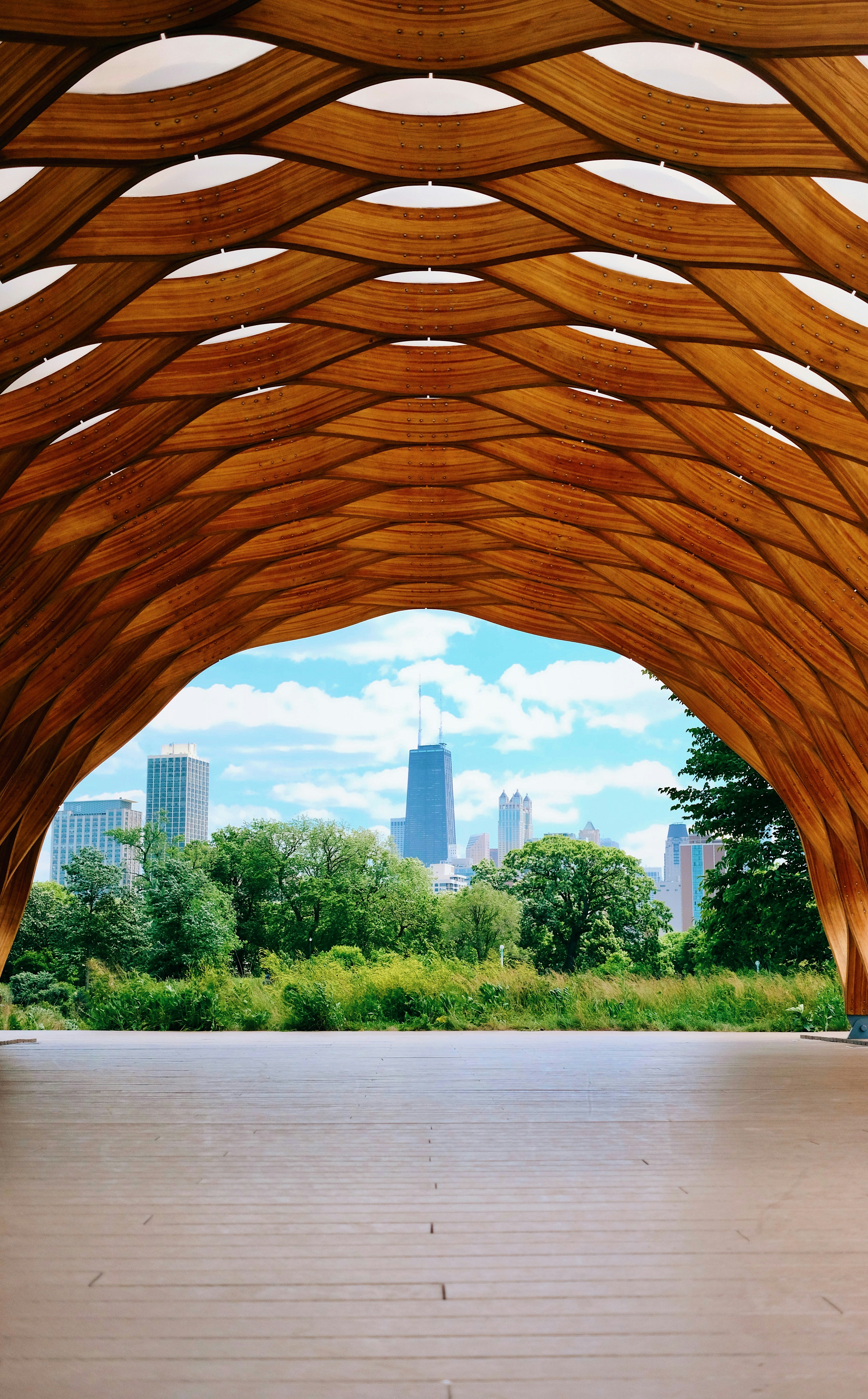 a large wooden structure with a city in the background