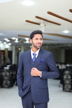 a man in a suit standing in a room