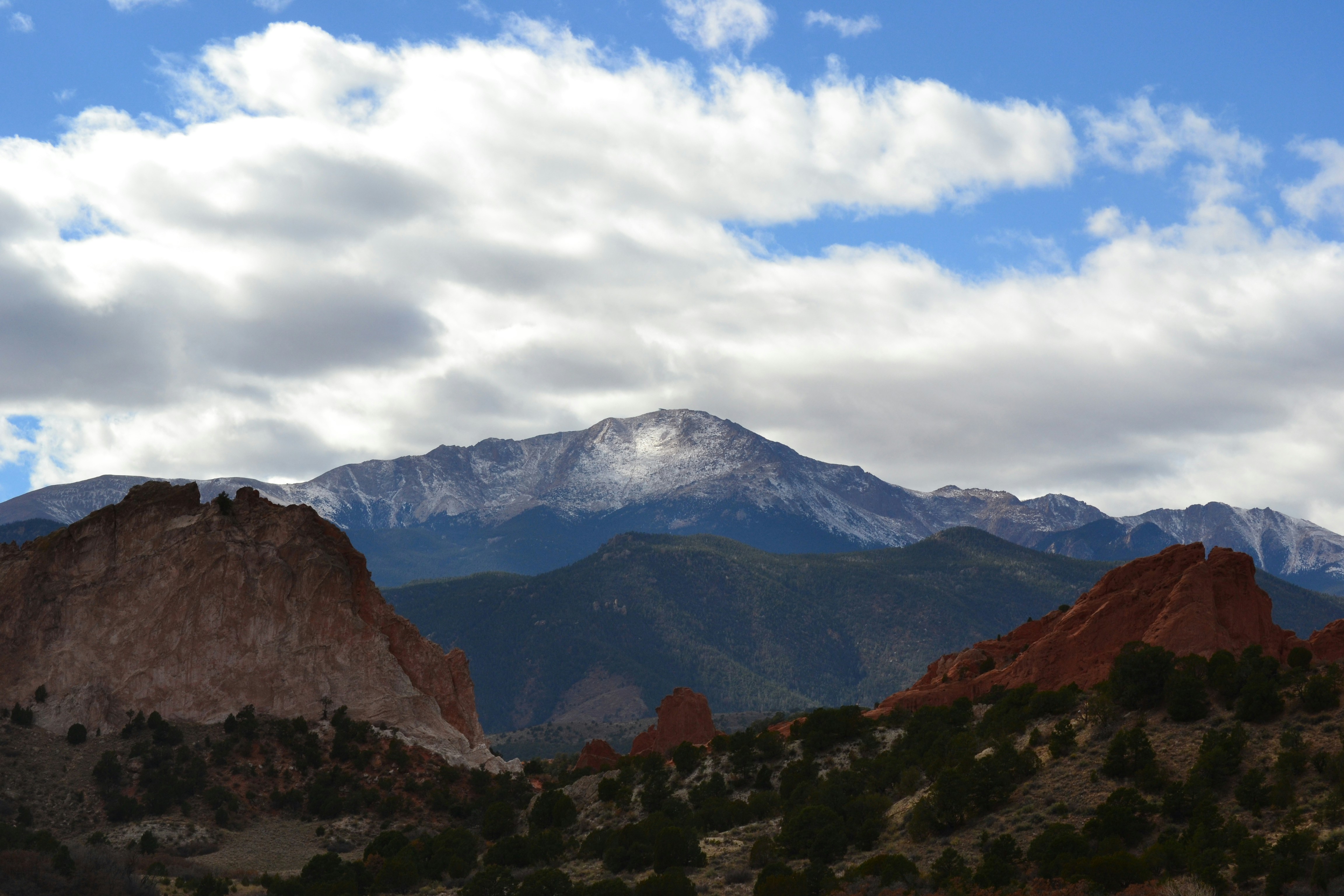 a mountain range with snow capped mountains in the background