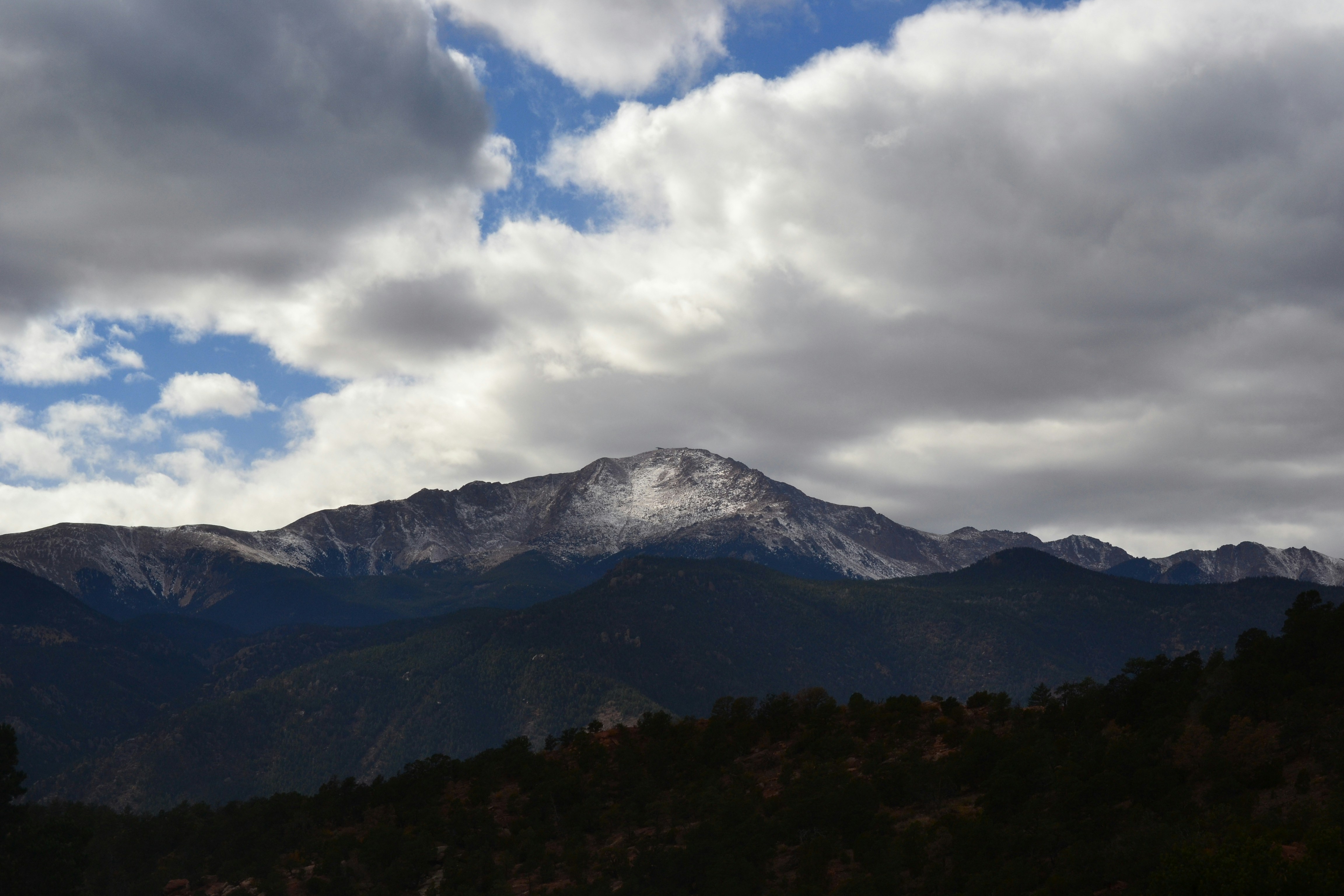 a view of a mountain range under a cloudy sky