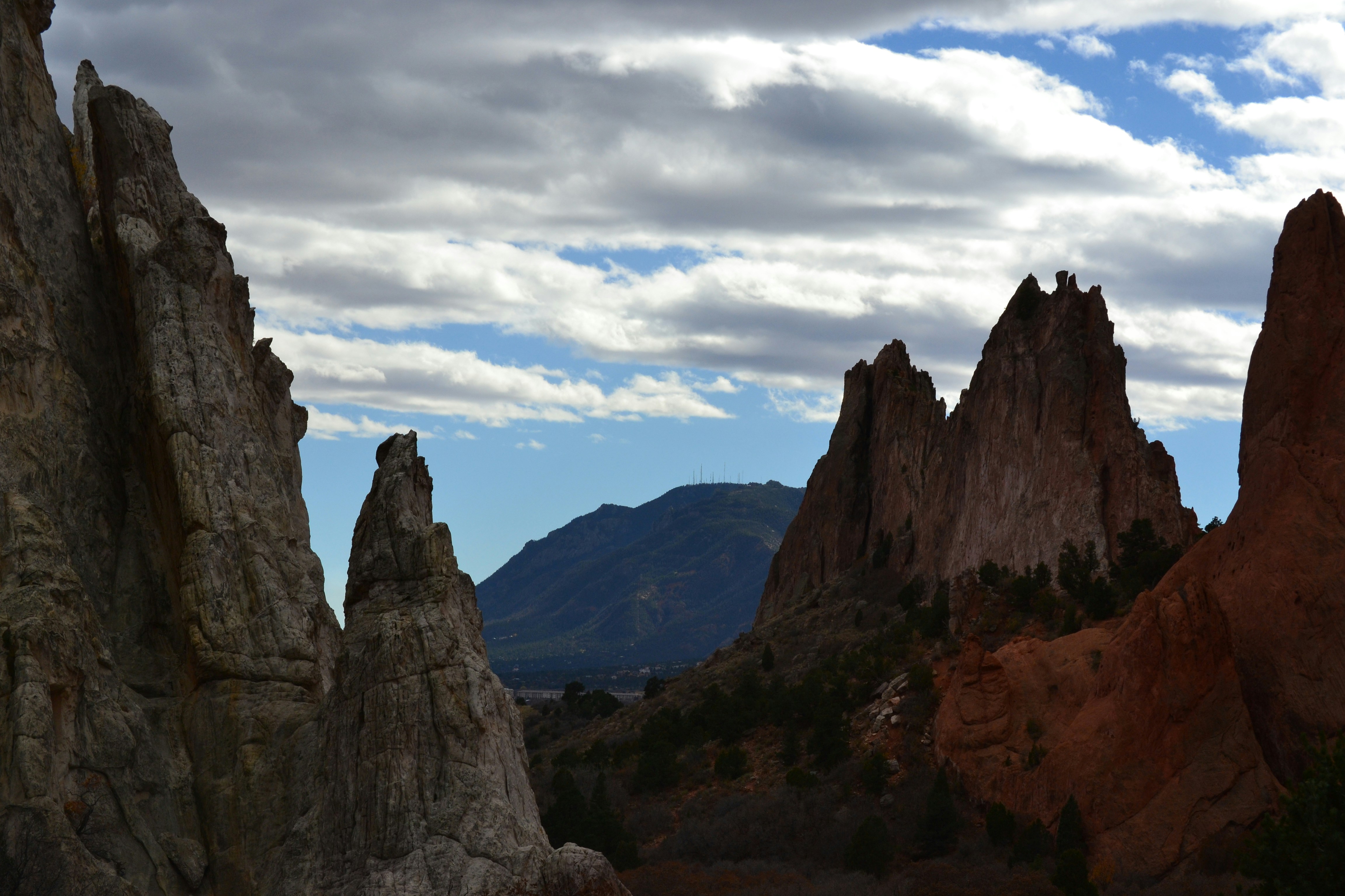 a group of rocks in the desert under a cloudy sky