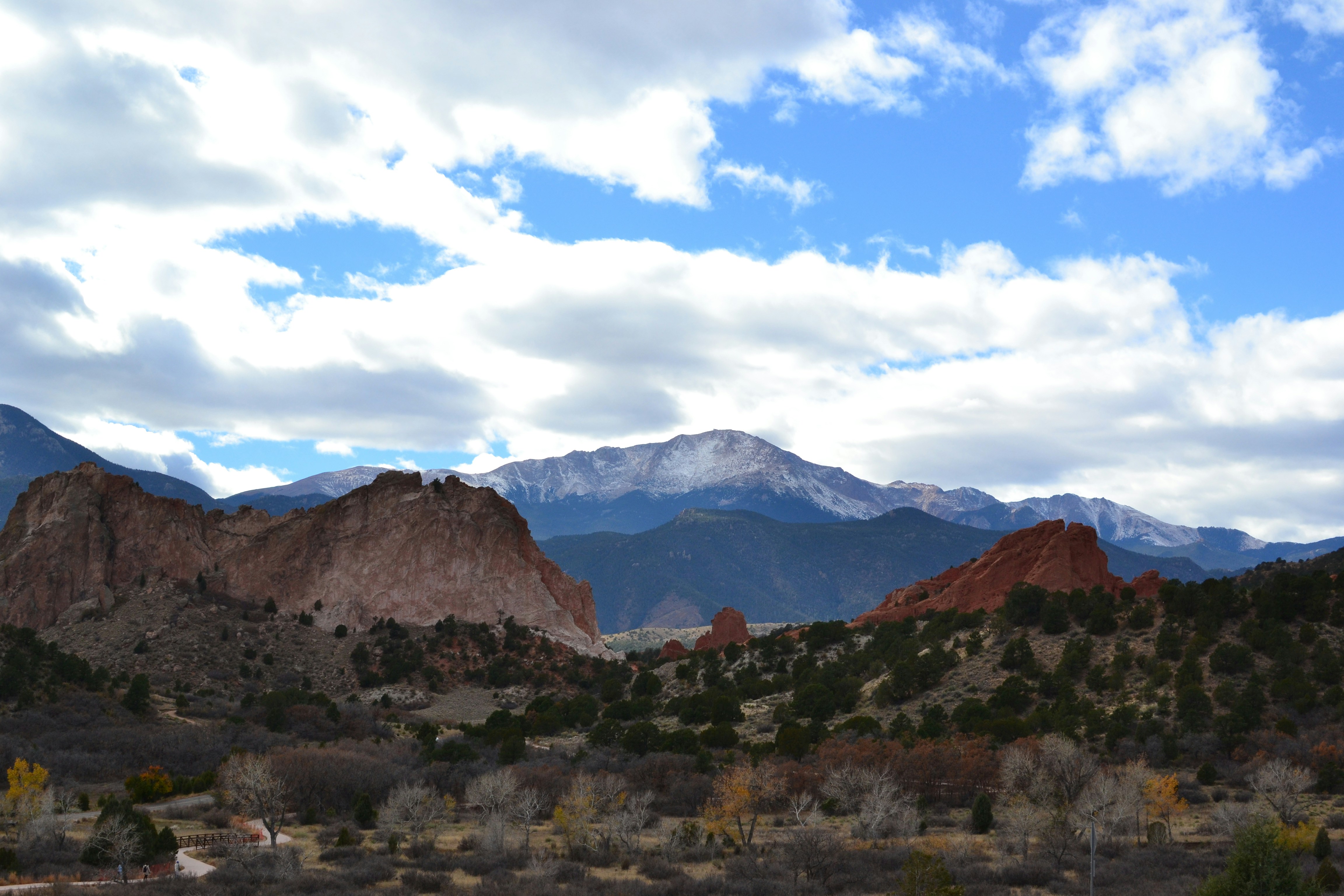 a mountain range with a few clouds in the sky