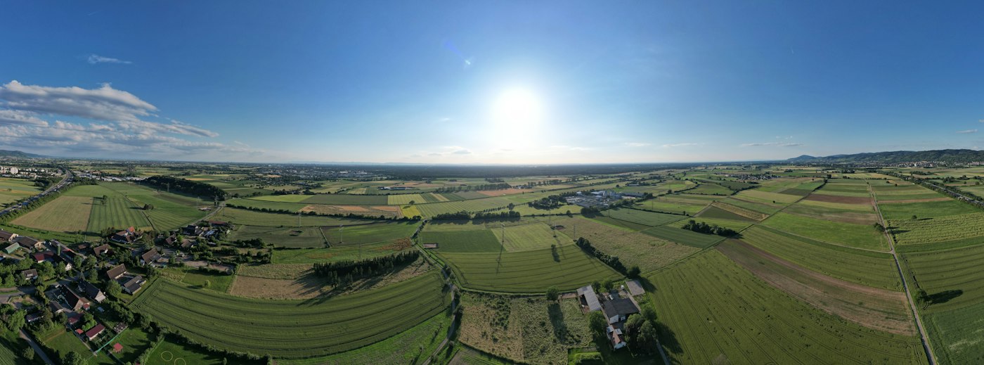 Aerial view of green patchwork farmland and treelines