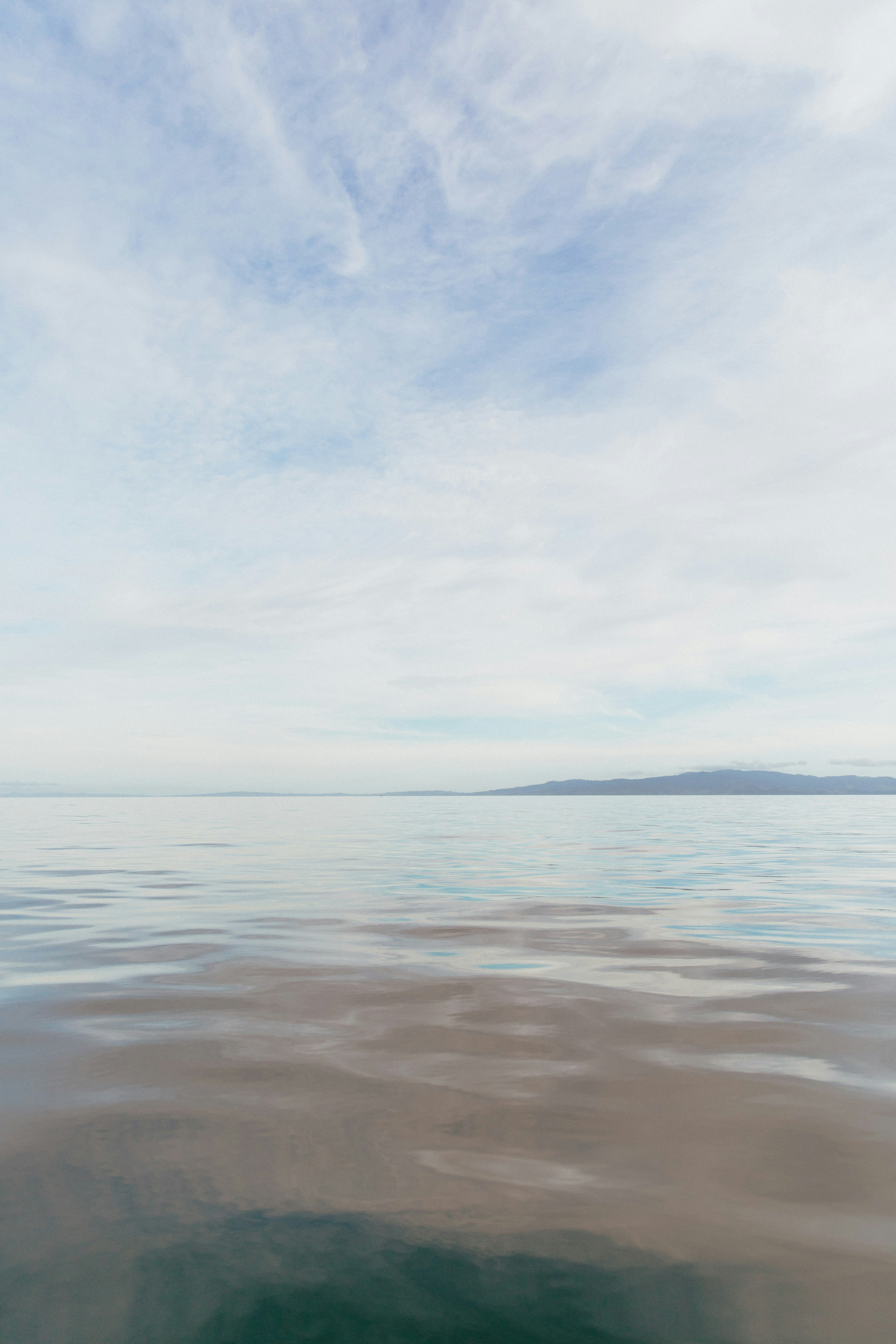 woman wearing yellow long-sleeved dress under white clouds and blue sky during daytime