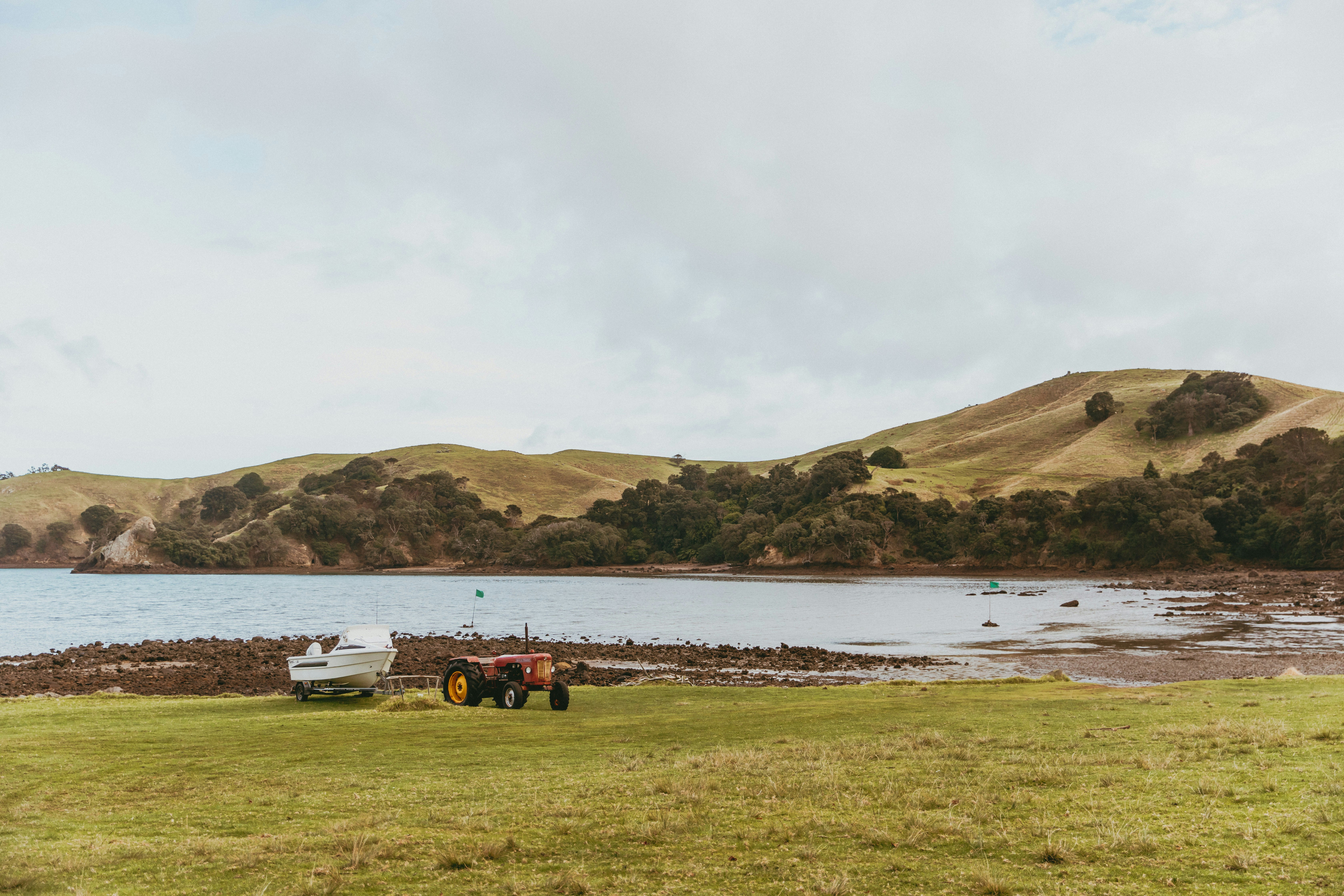 a tractor parked in a field next to a body of water