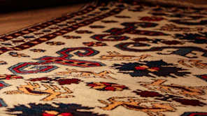 a close up of a rug on a wooden floor