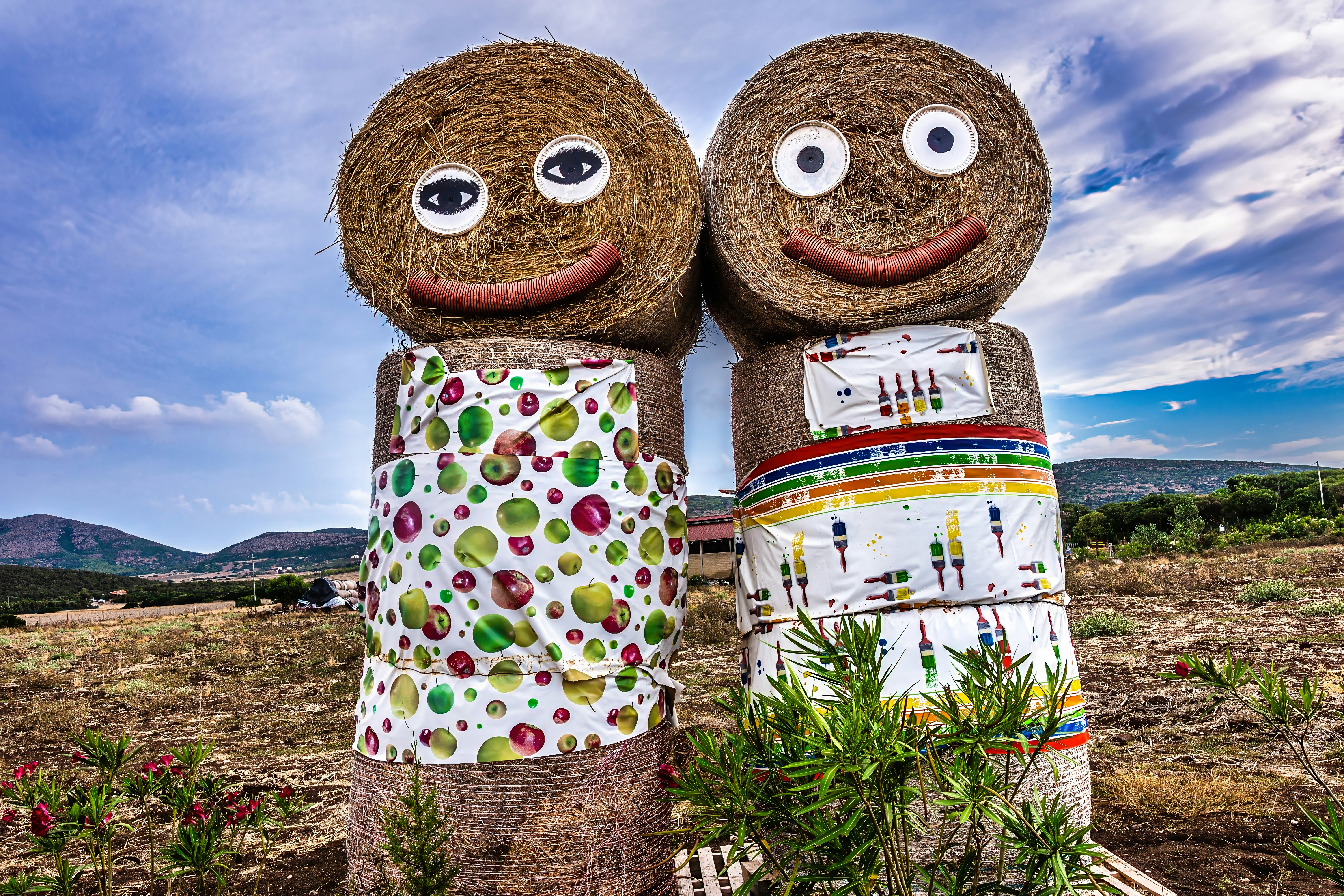 a couple of hay dolls standing next to each other