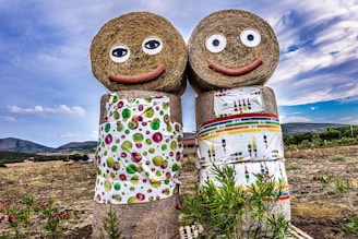 a couple of hay dolls standing next to each other