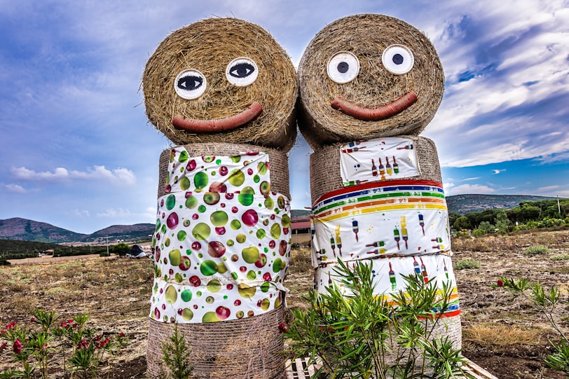 a couple of hay dolls standing next to each other