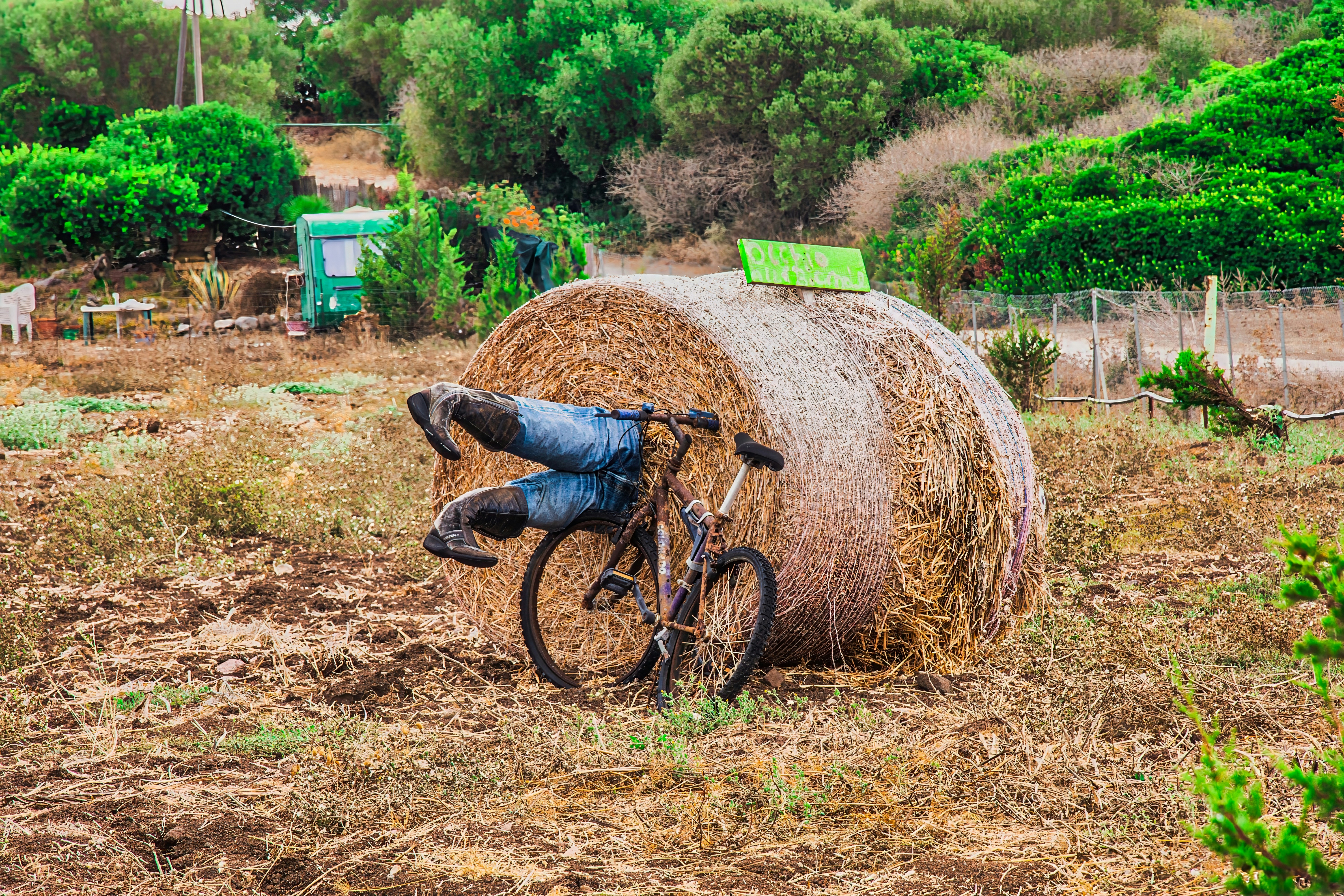a bicycle leaning against a bale of hay