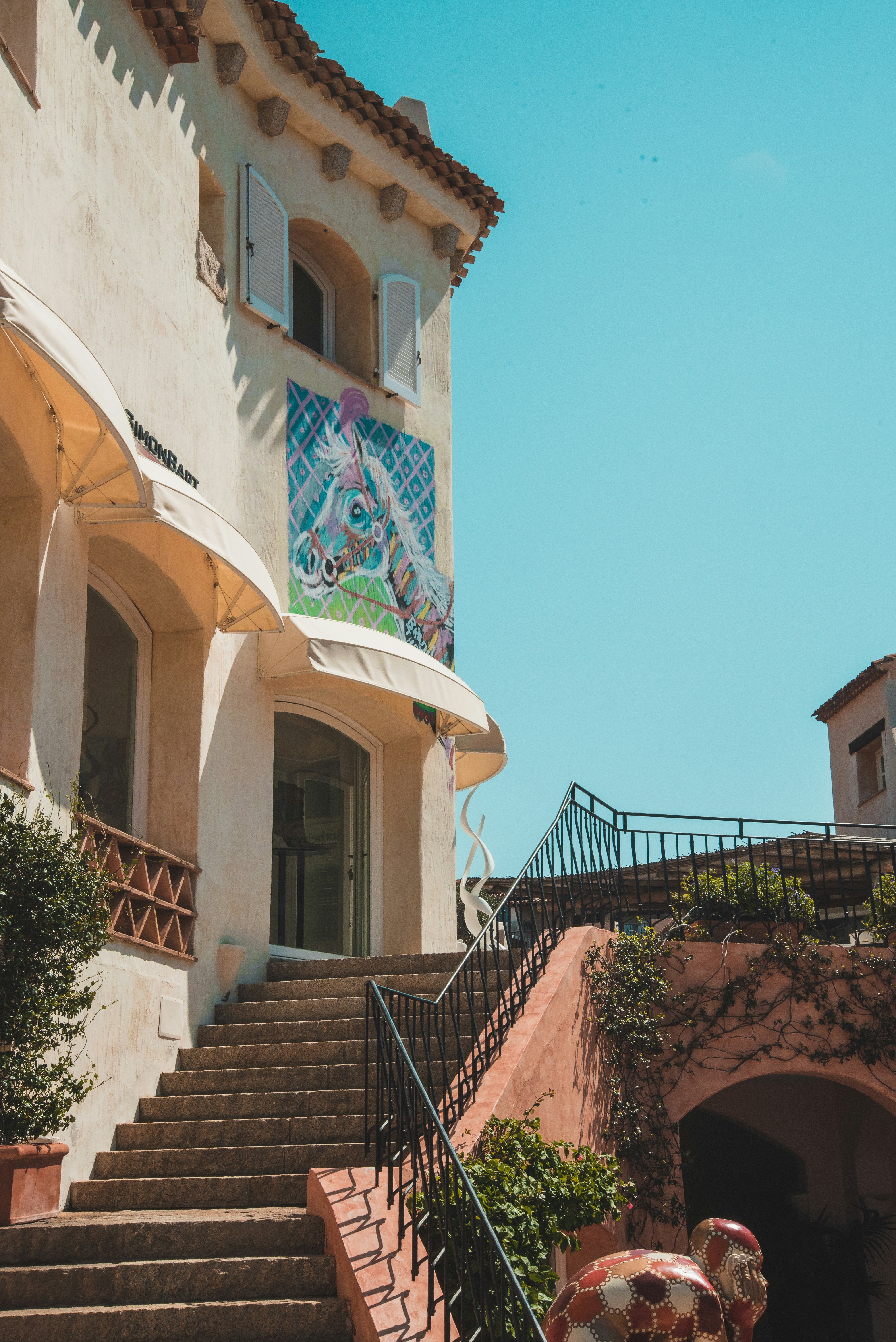 a staircase leading up to a building with a mural on it