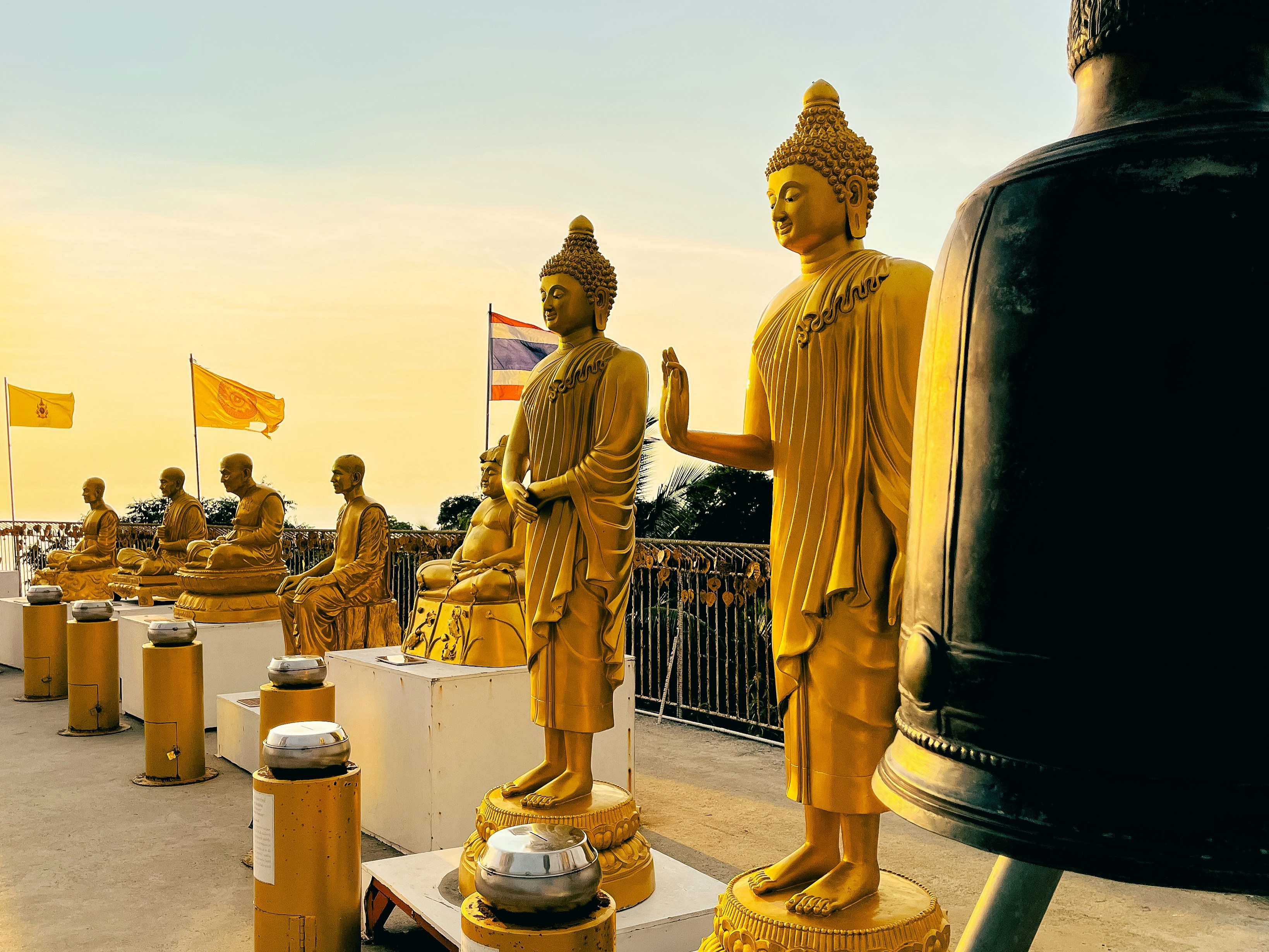 a row of golden buddha statues sitting next to each other