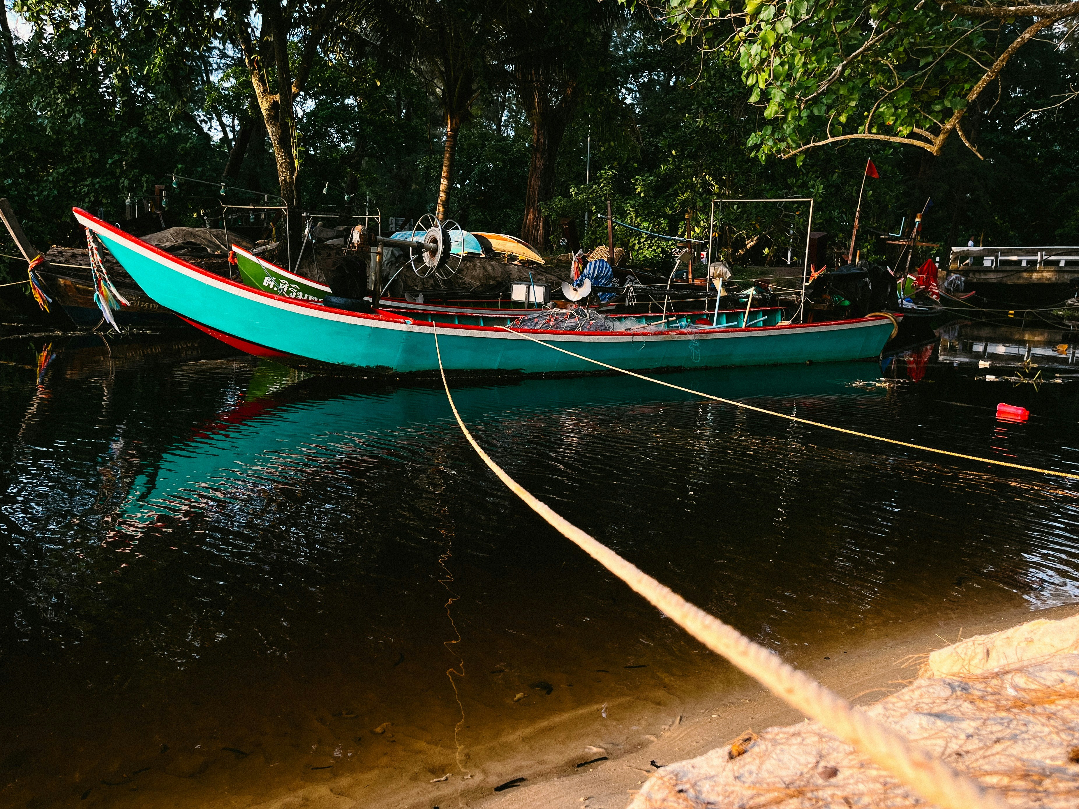 a boat tied up to a dock in the water